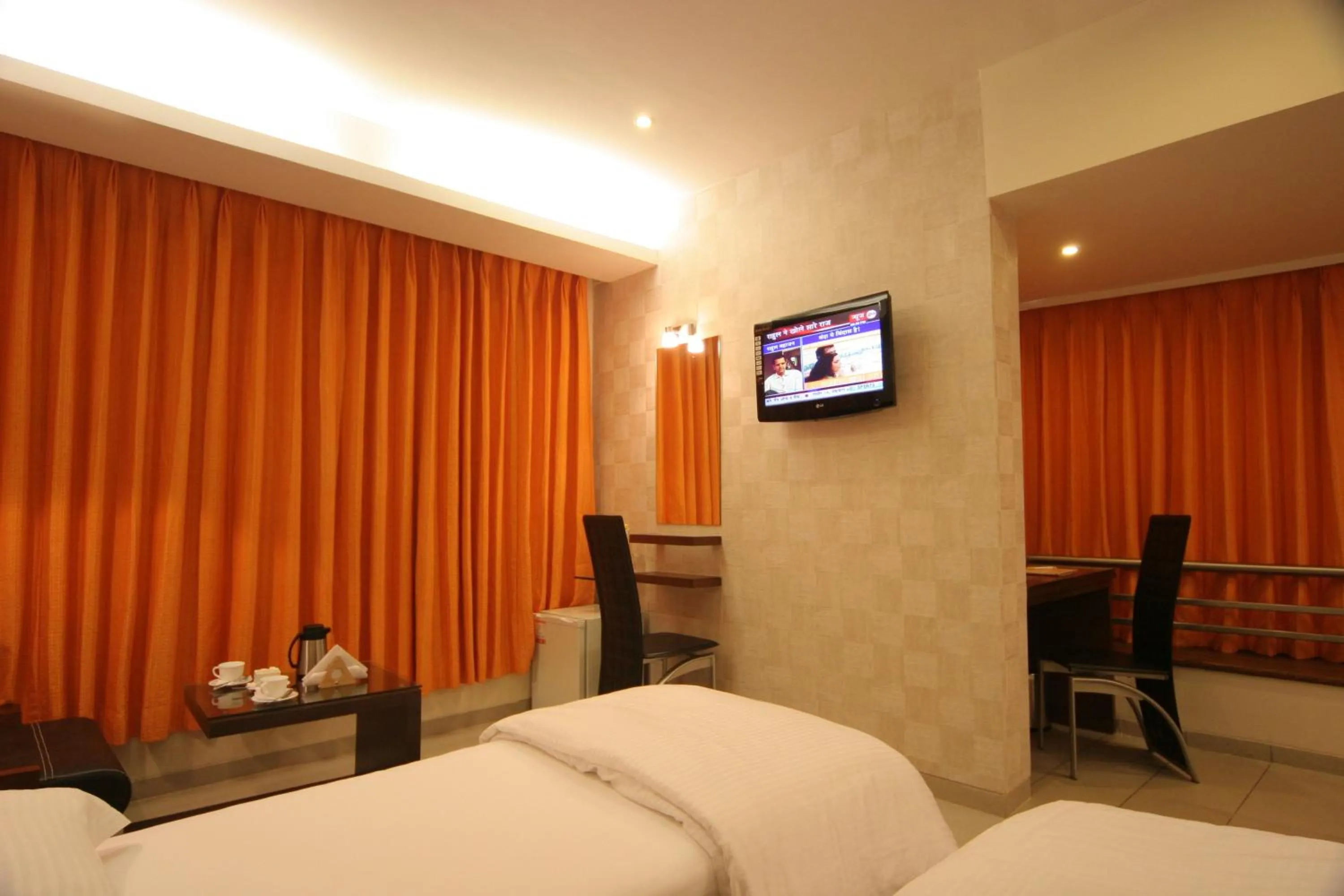 Communal lounge/ TV room, Bed in Pride Biznotel Alkapuri Near Vadodara Airport
