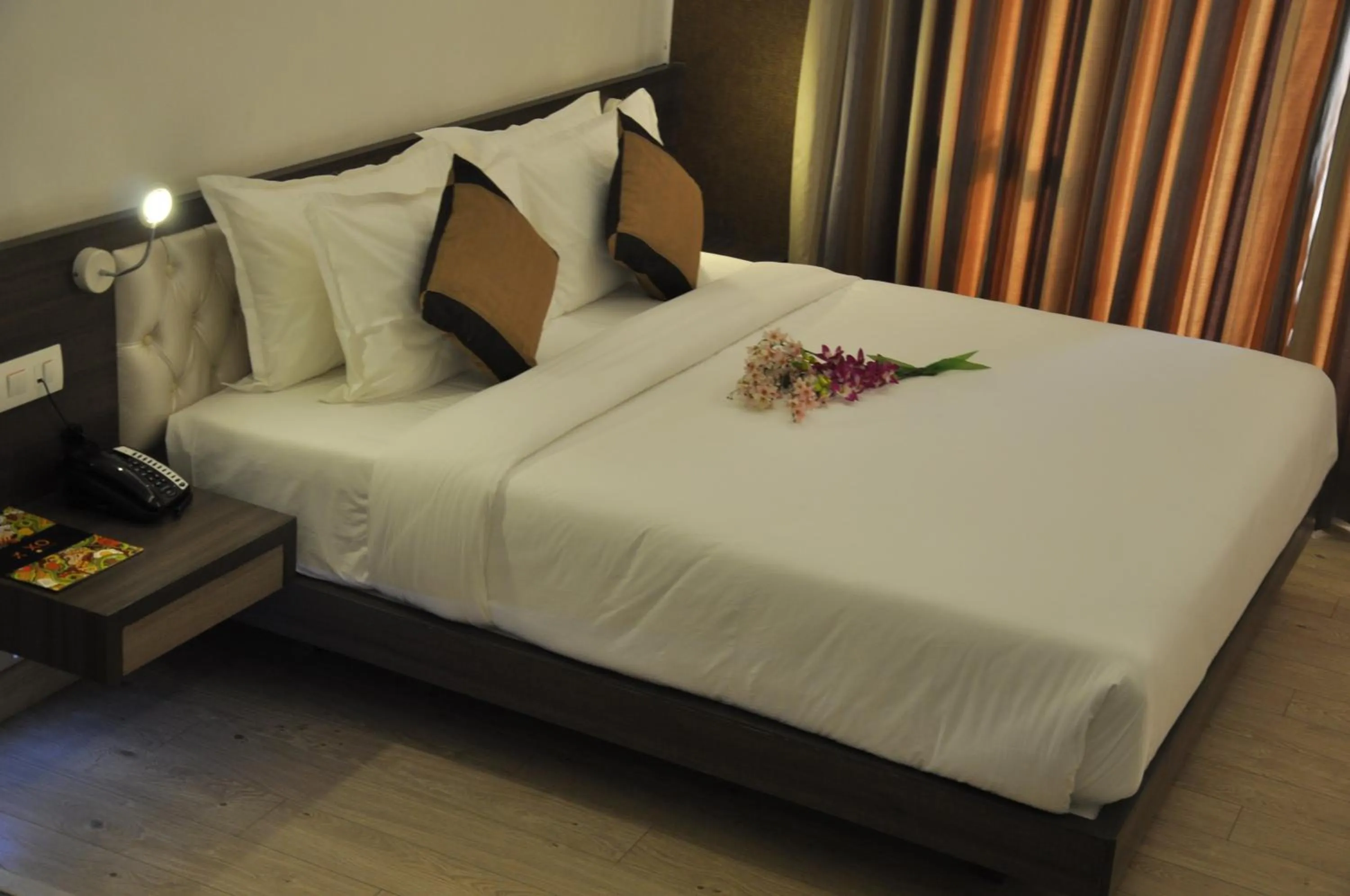 Bed in Pride Biznotel Manjusar Vadodara Near Sokhda Lake