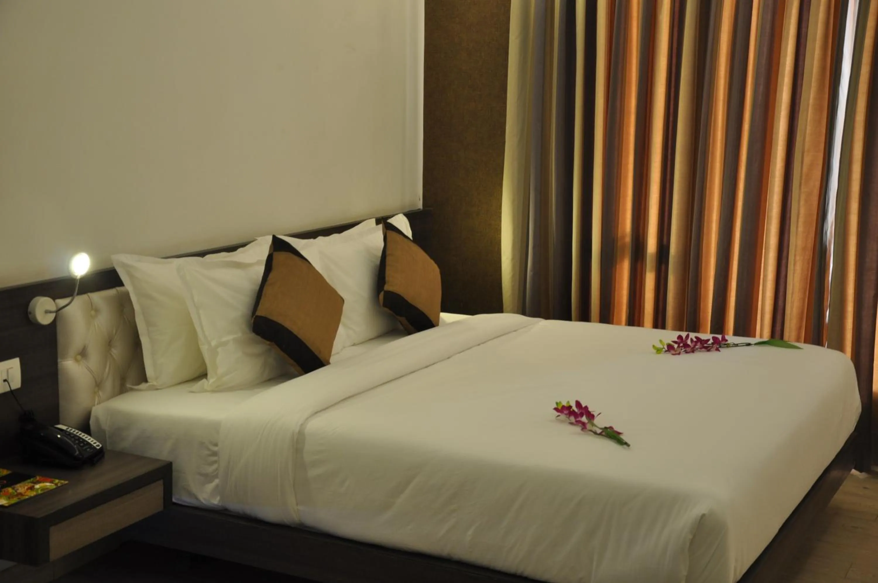 Bed in Pride Biznotel Manjusar Vadodara Near Sokhda Lake
