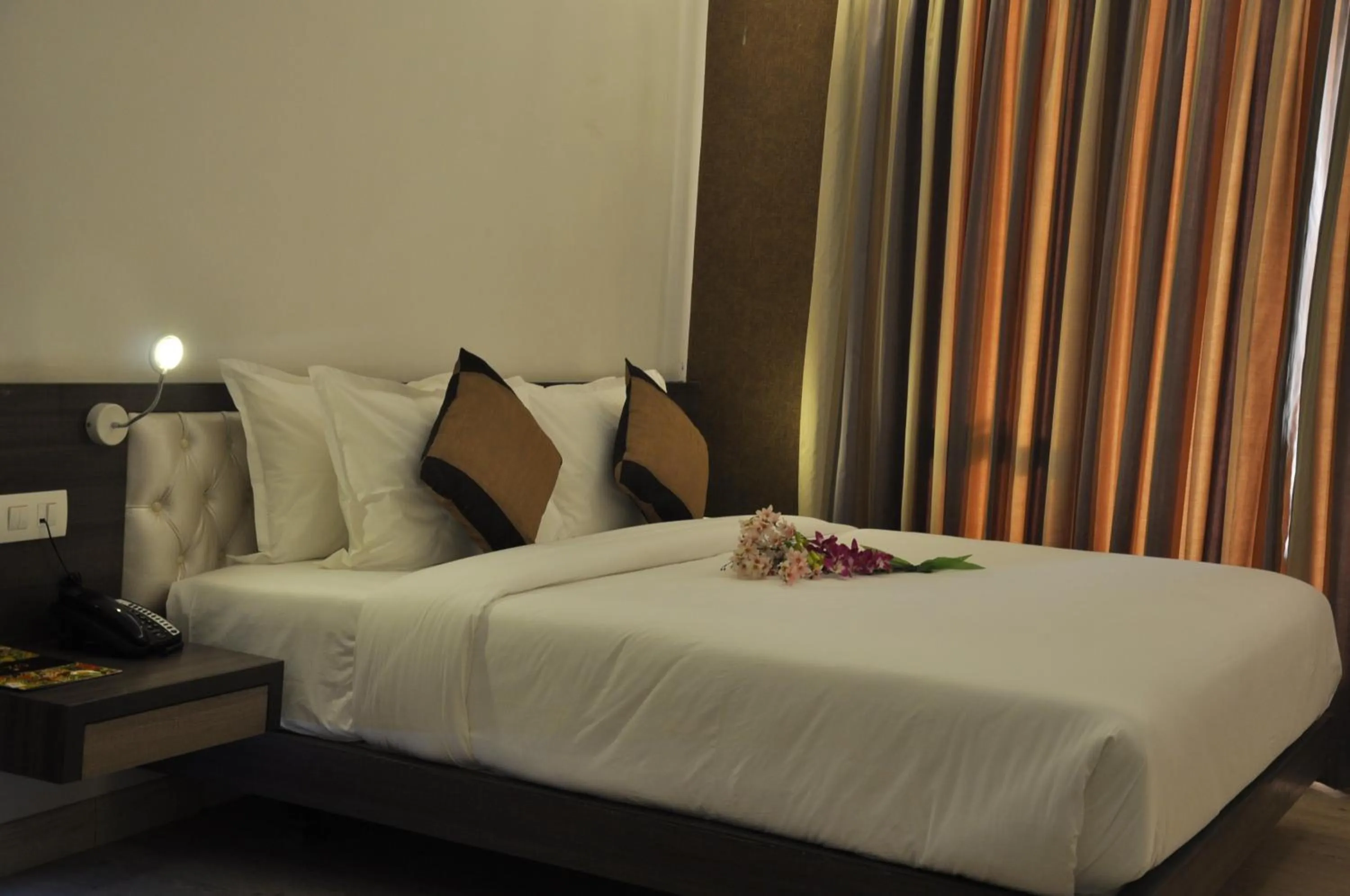 Bed in Pride Biznotel Manjusar Vadodara Near Sokhda Lake