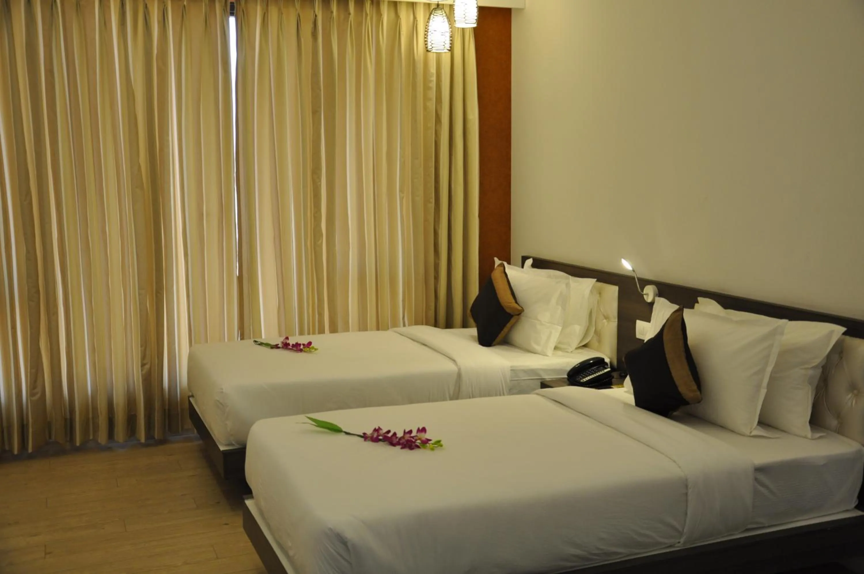 Bed in Pride Biznotel Manjusar Vadodara Near Sokhda Lake