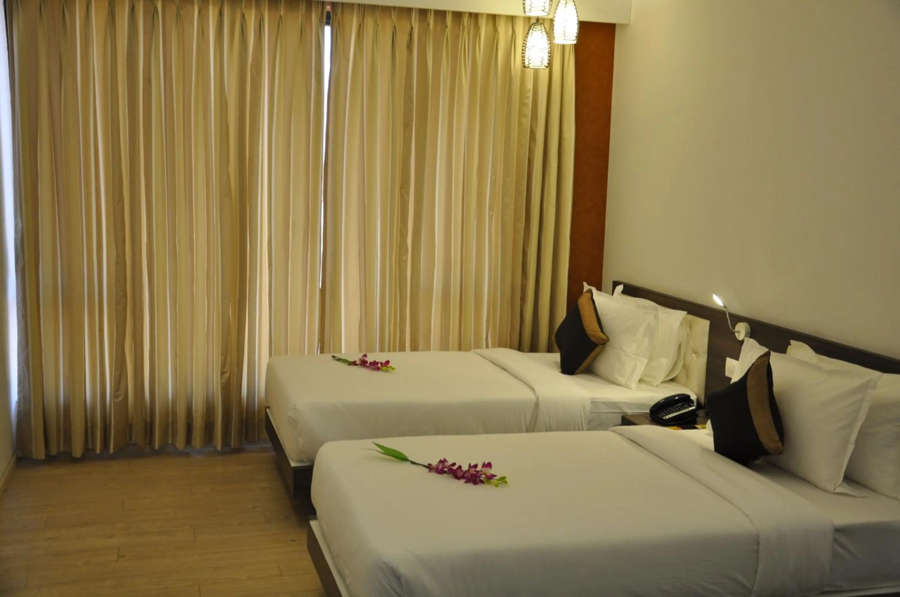 Photo of the whole room, Bed in Pride Biznotel Manjusar Vadodara Near Sokhda Lake