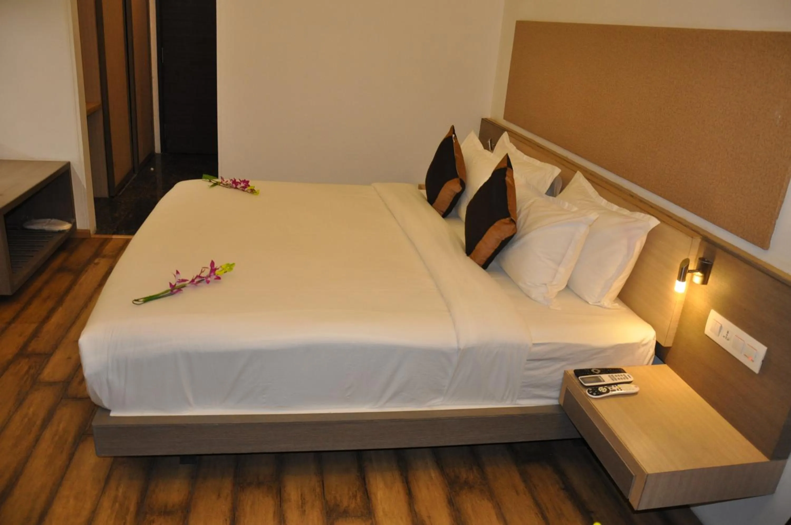 Bed in Pride Biznotel Manjusar Vadodara Near Sokhda Lake