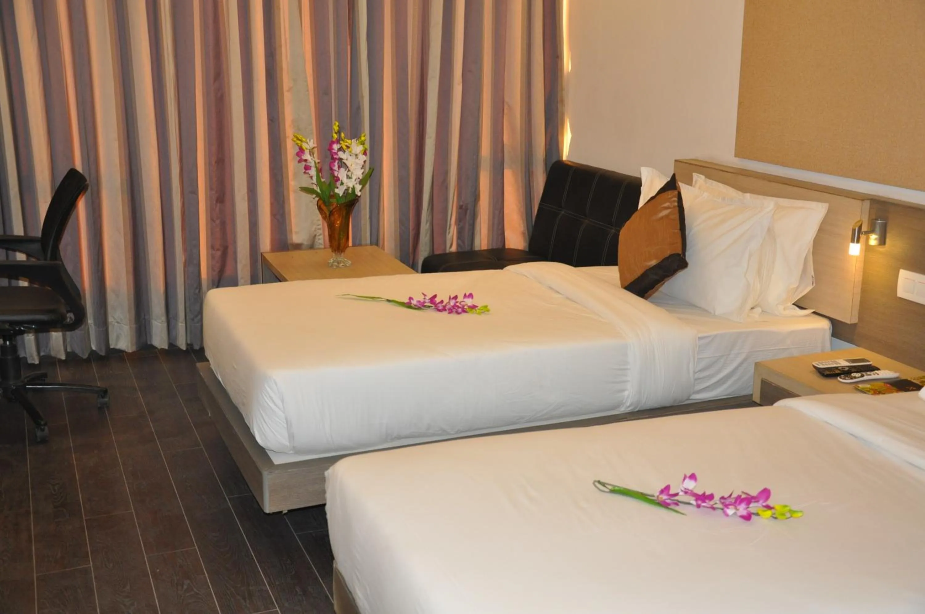 Bed in Pride Biznotel Manjusar Vadodara Near Sokhda Lake