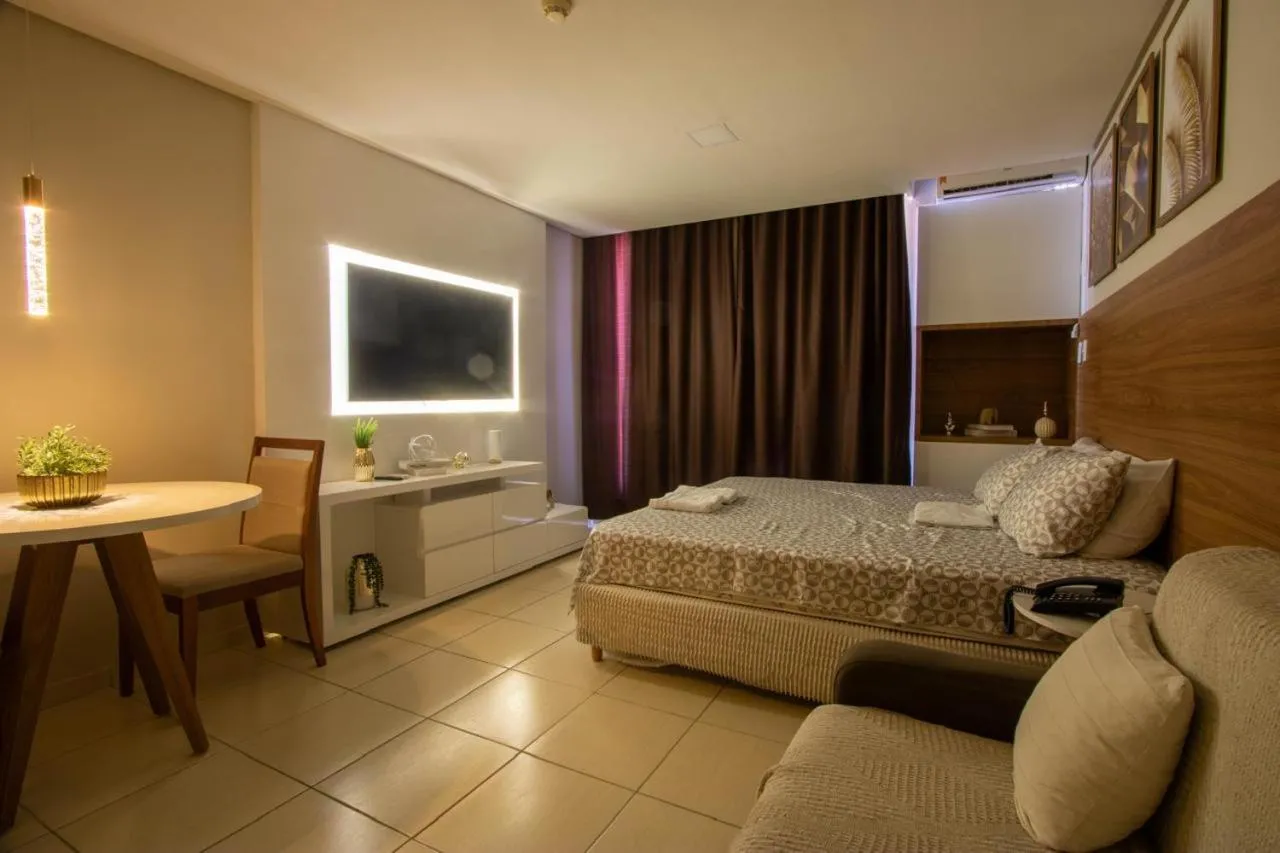 Bed in Suíte luxo com tela de cinema no América Towers Studio Residence