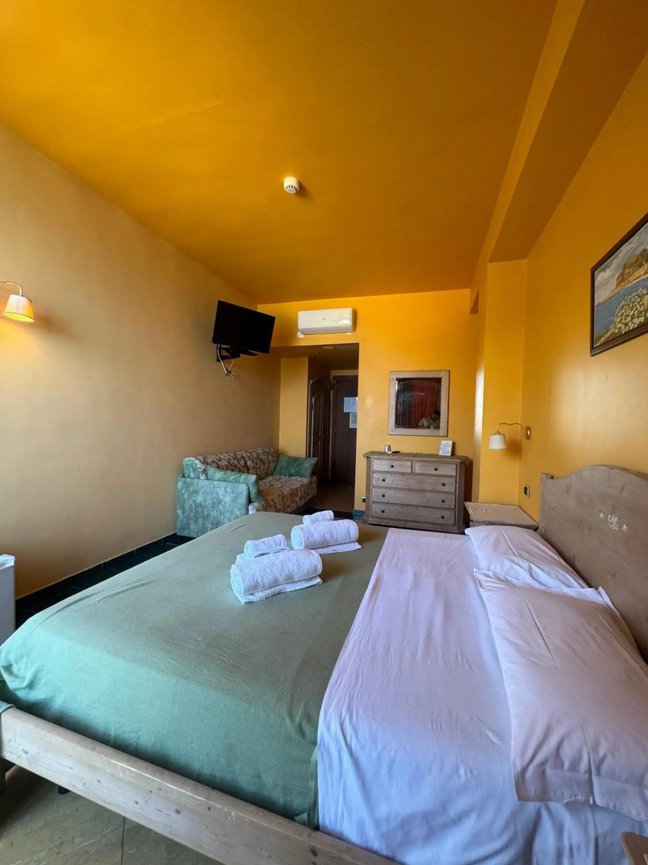 Communal lounge/ TV room, Bed in Hotel La Playa Blanca Communal lounge/ TV room, Bed in Hotel La Playa Blanca