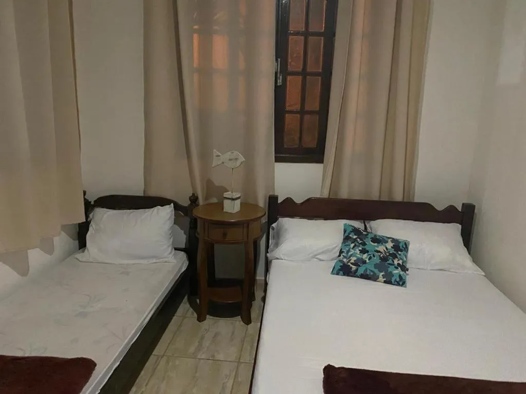 Bed in Pousada Casa de mãe aconchegante com piscina próximo à praia