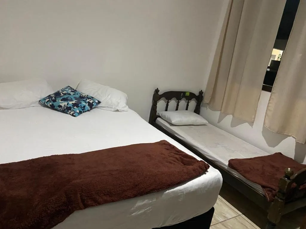 Bed in Pousada Casa de mãe aconchegante com piscina próximo à praia
