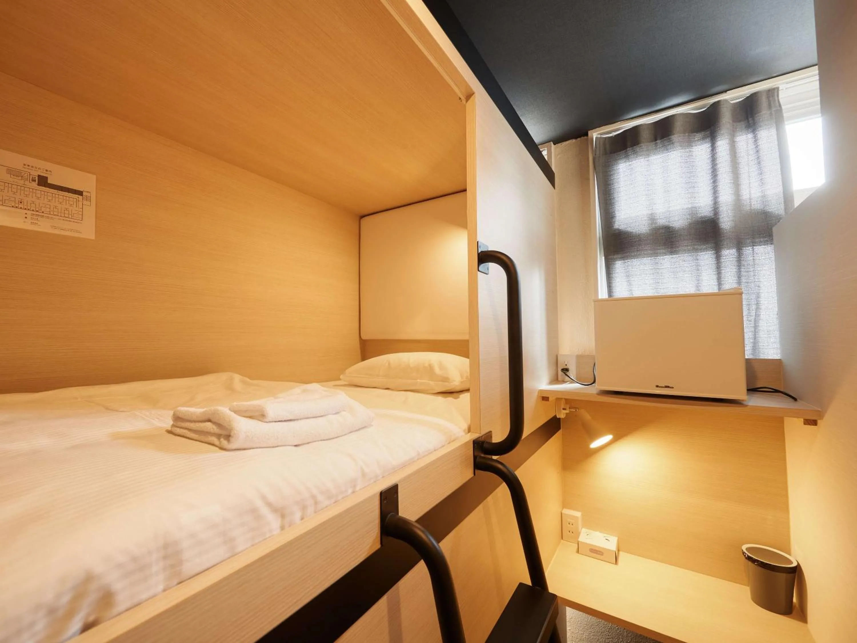 Bed in CABIN&HOTEL CONSTANT NAHA
