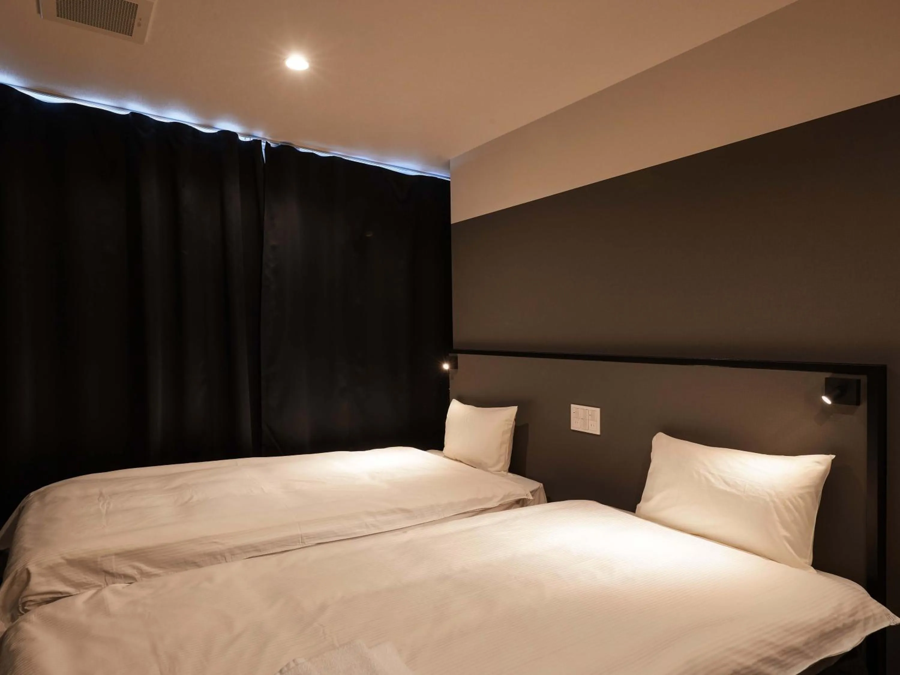 Bed in CABIN&HOTEL CONSTANT NAHA