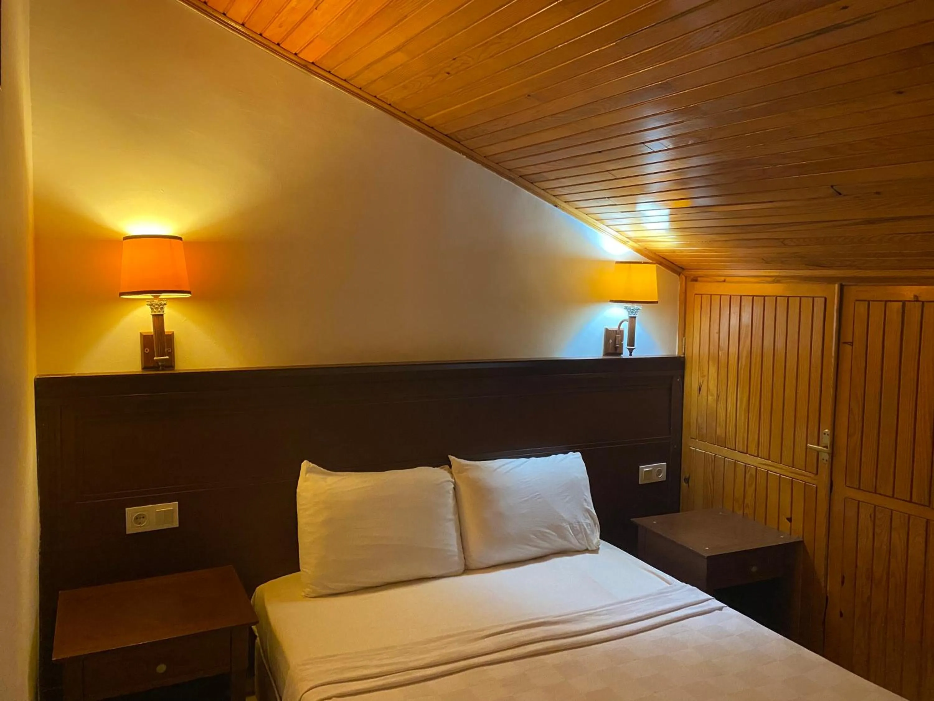 Bed in NATURELLA APART HOTEL