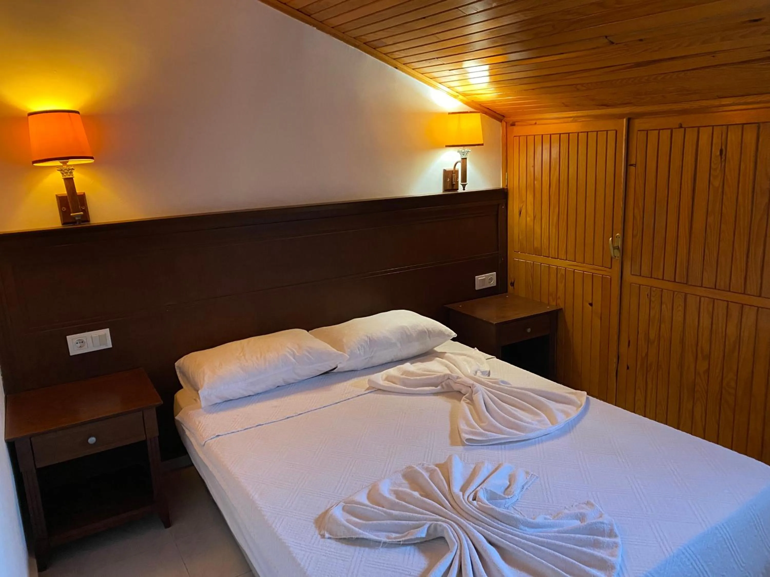 Bed in NATURELLA APART HOTEL