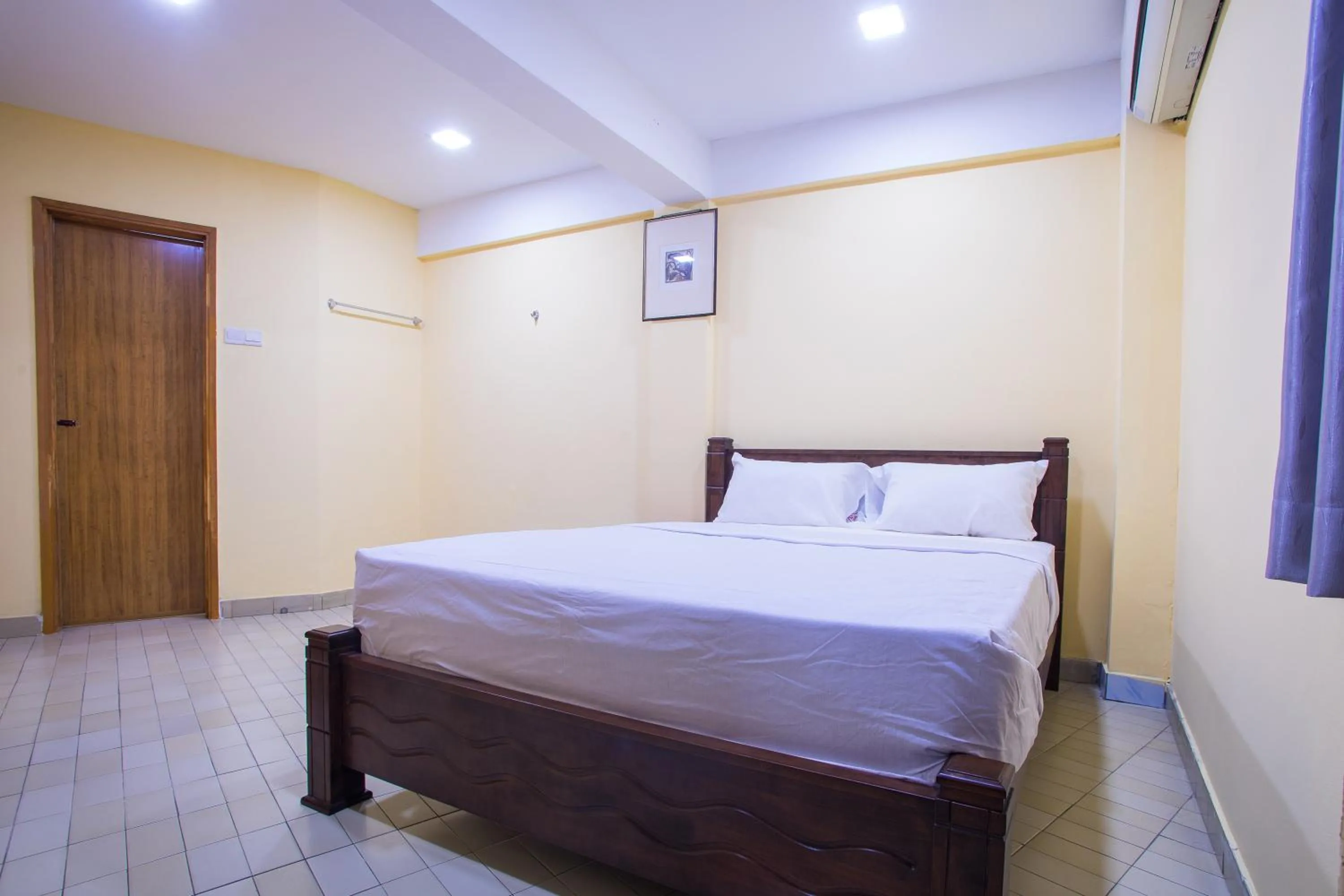 Bed in MK Inn Hotel