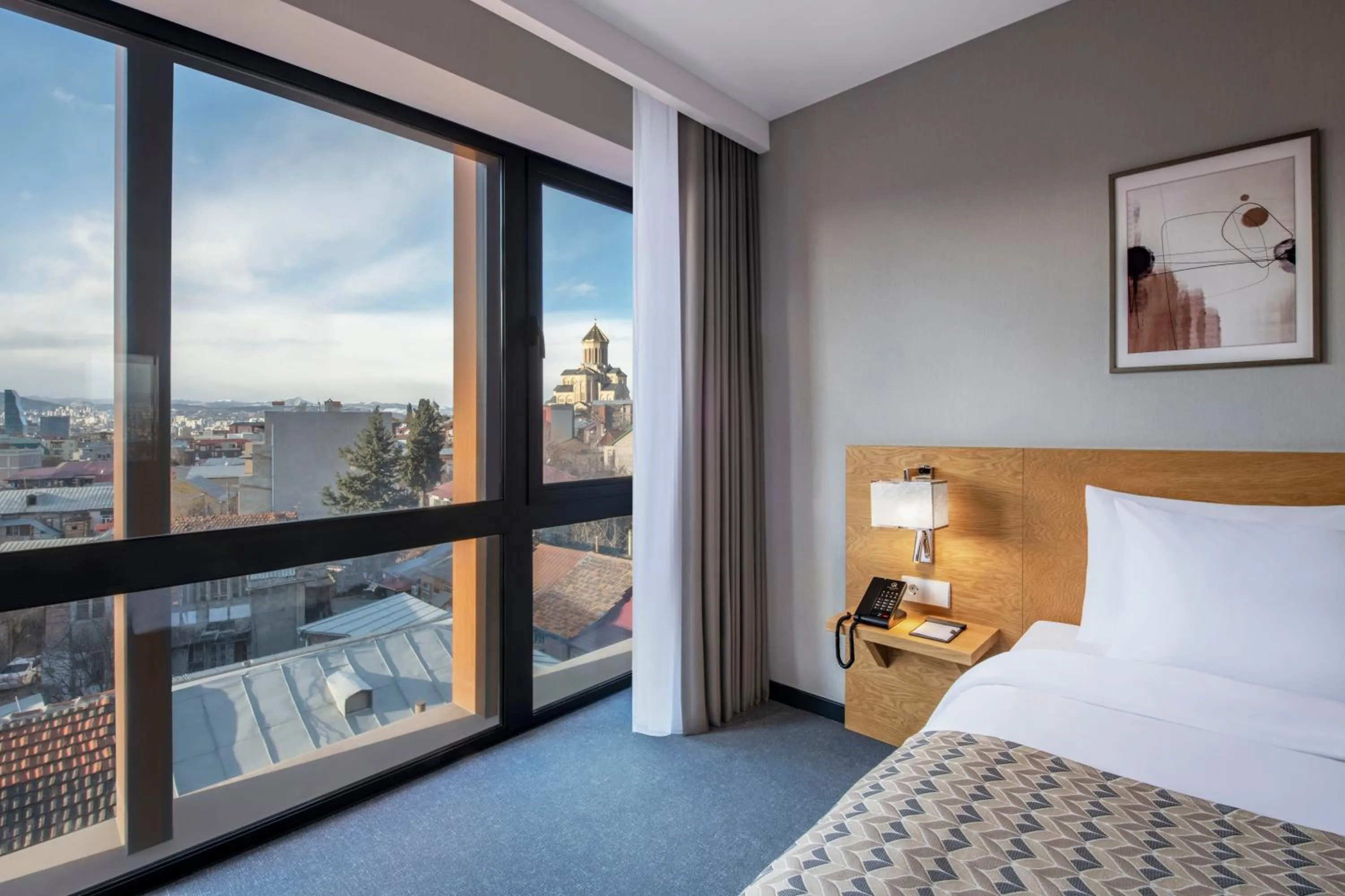 Bed in Clocks Hotel Tbilisi