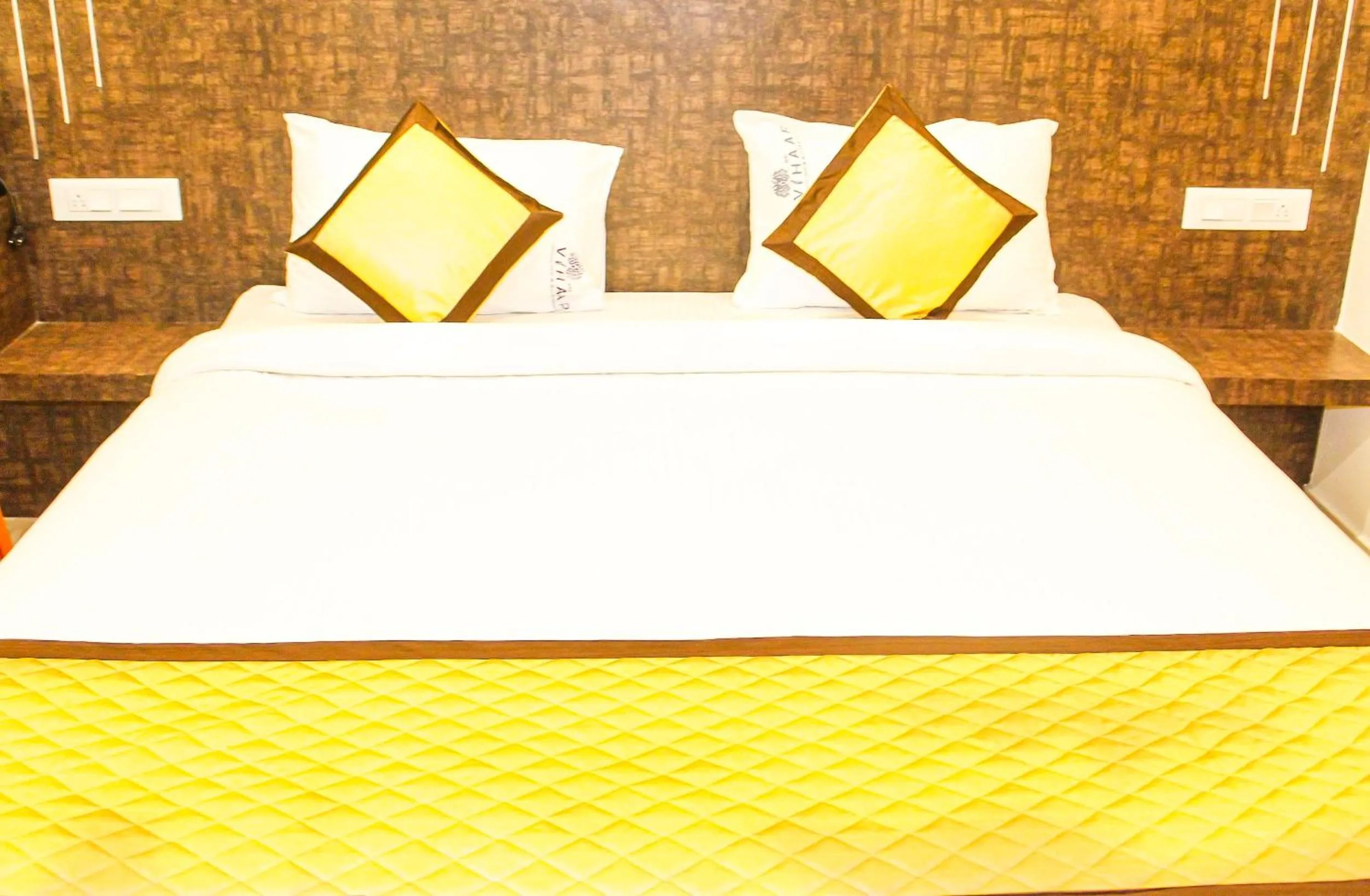Bed in Sai Vihaar Inn & Suites
