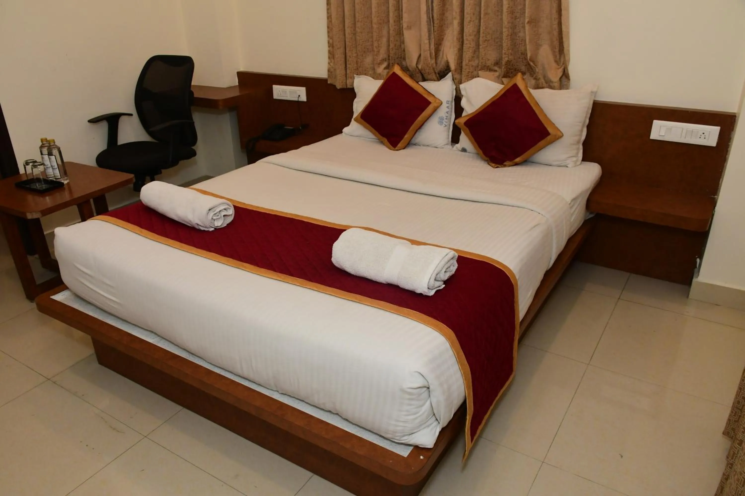 Bed in Sai Vihaar Inn & Suites