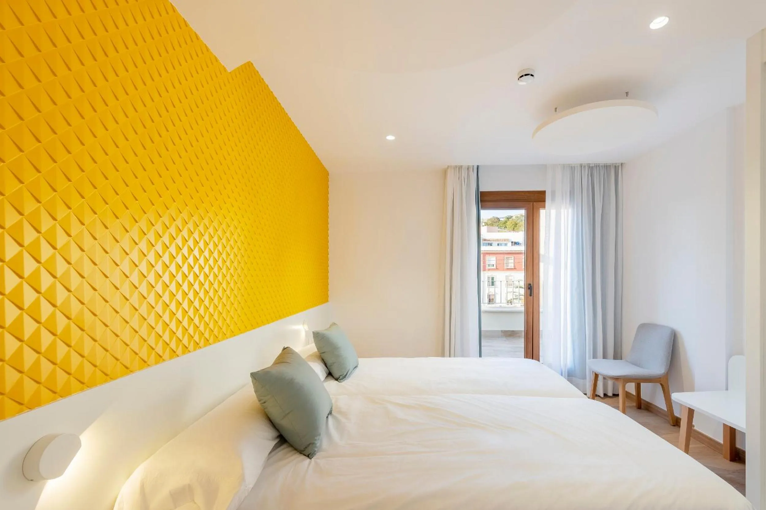 Bed in Odyssey Rooms Alicante