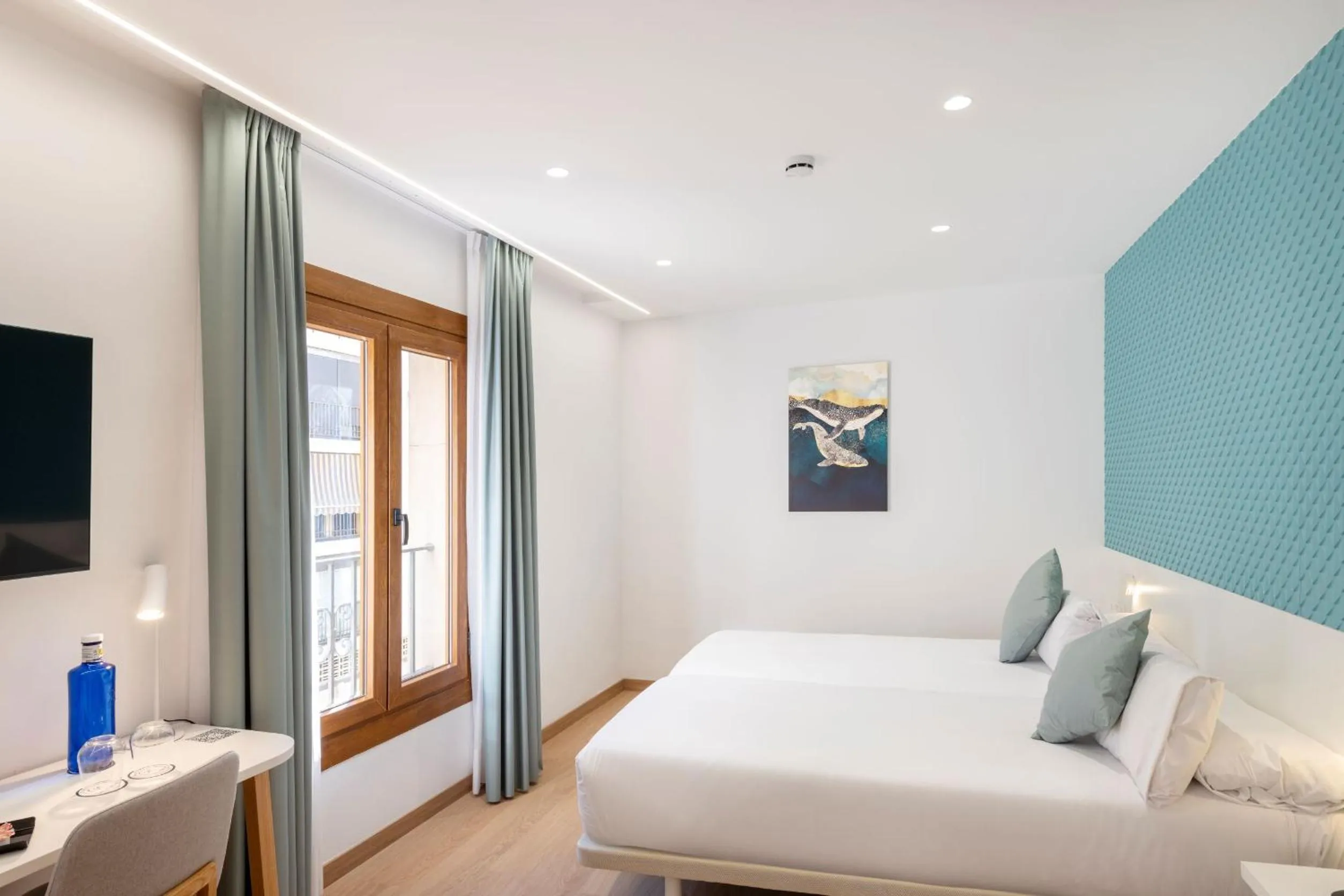 Bed in Odyssey Rooms Alicante