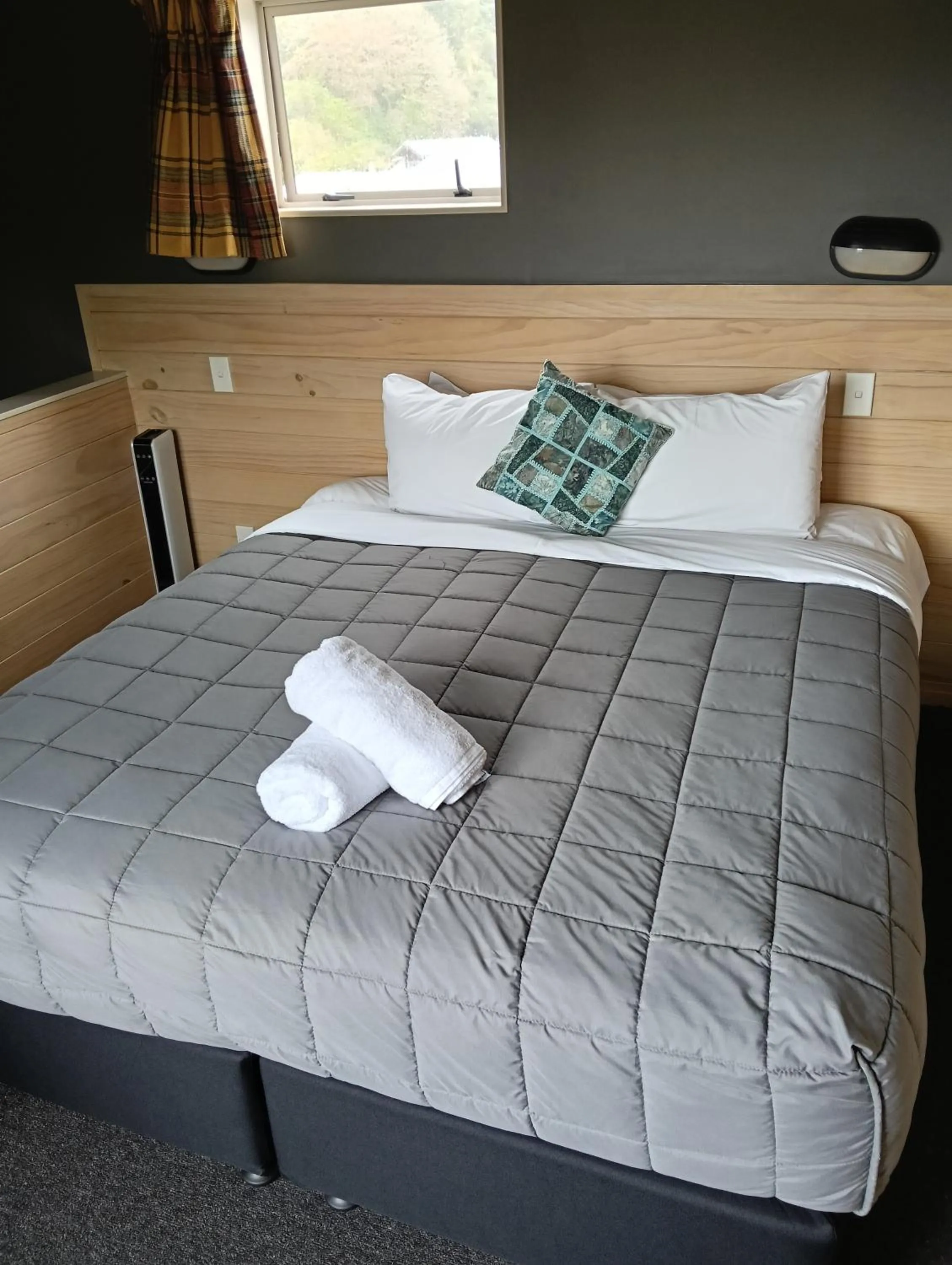 Bed in Waitomo Village Chalets home of Kiwipaka