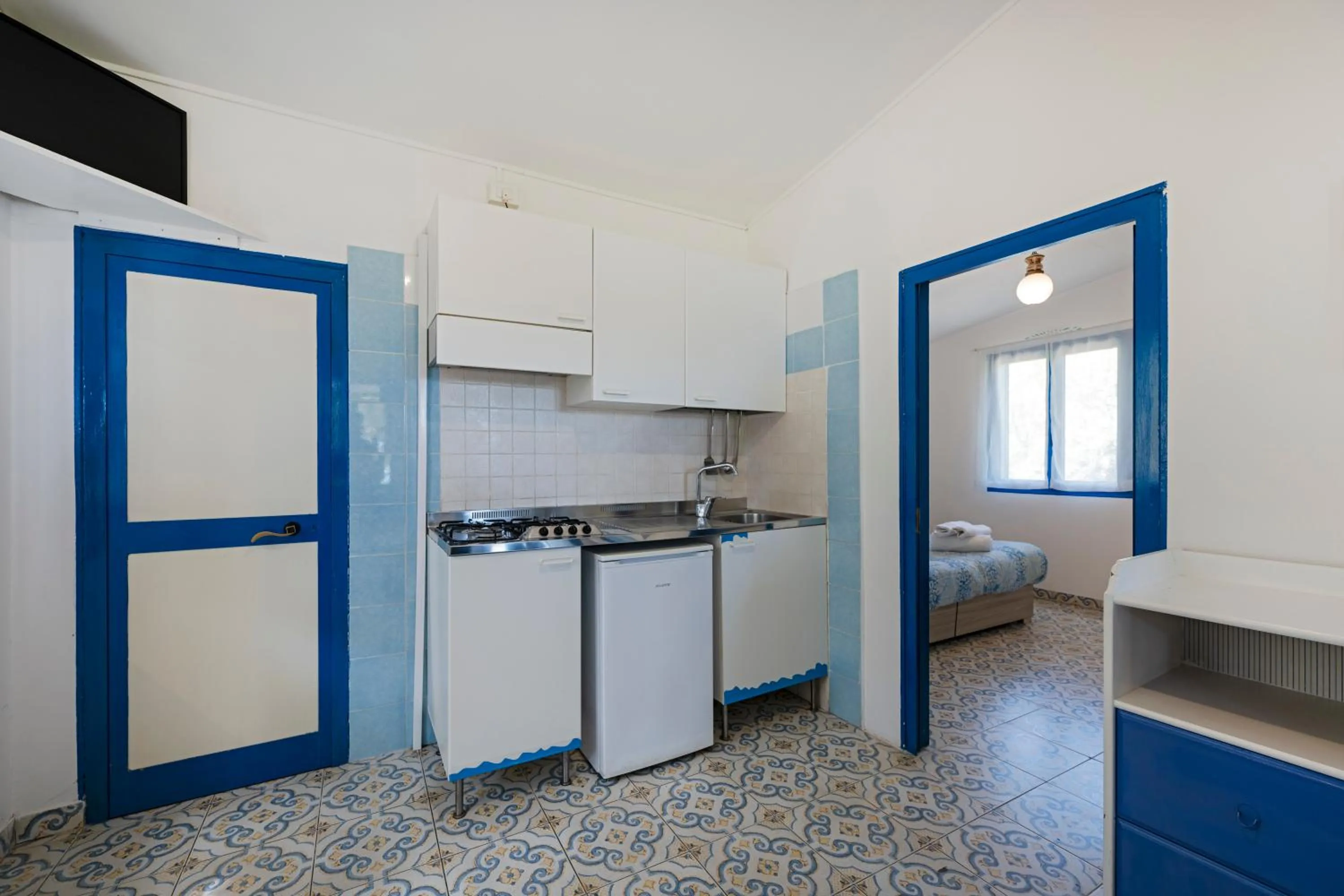 Kitchen or kitchenette, Bed in Villaggio Residence Nettuno