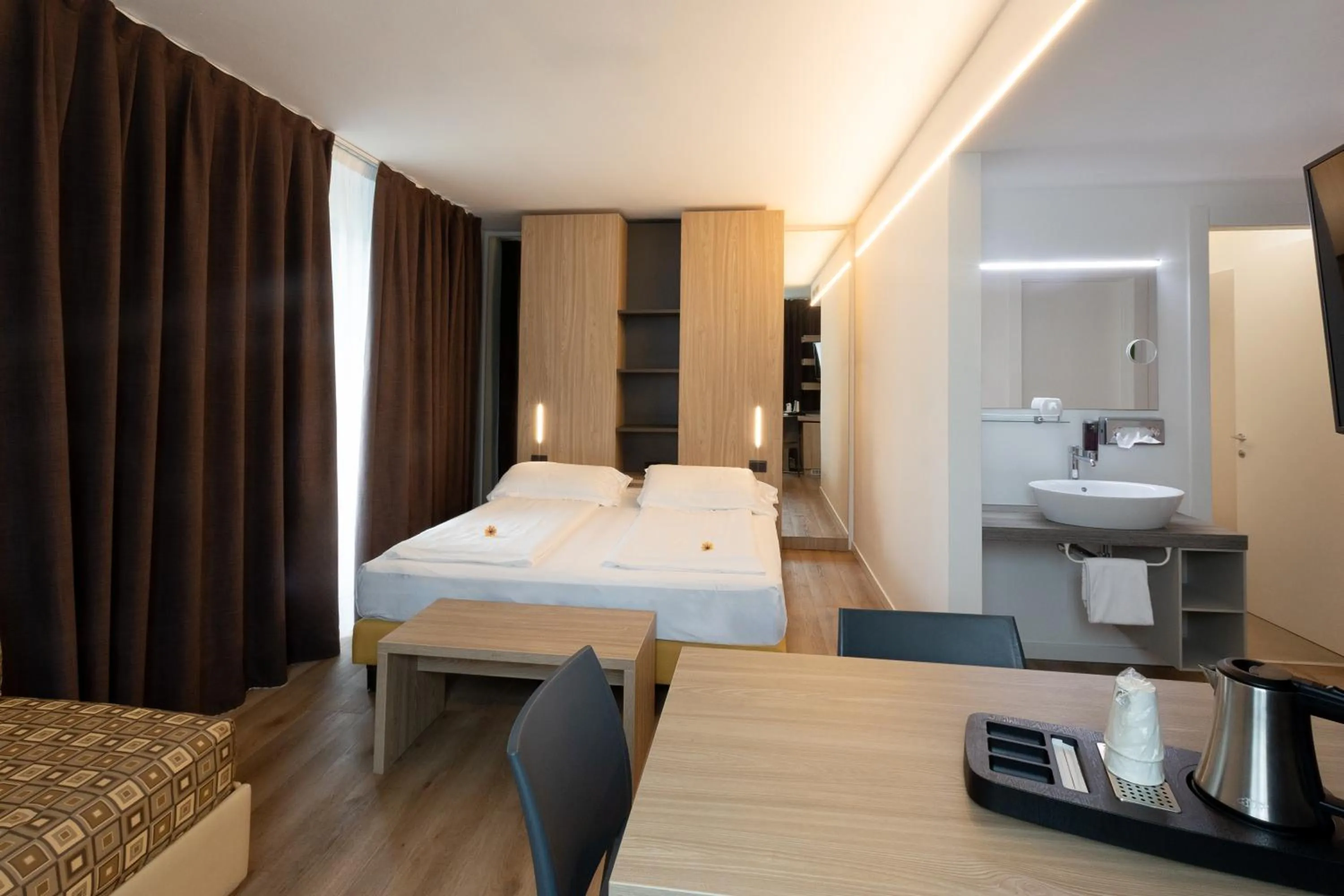 Bed in Ambassador Suite Hotel