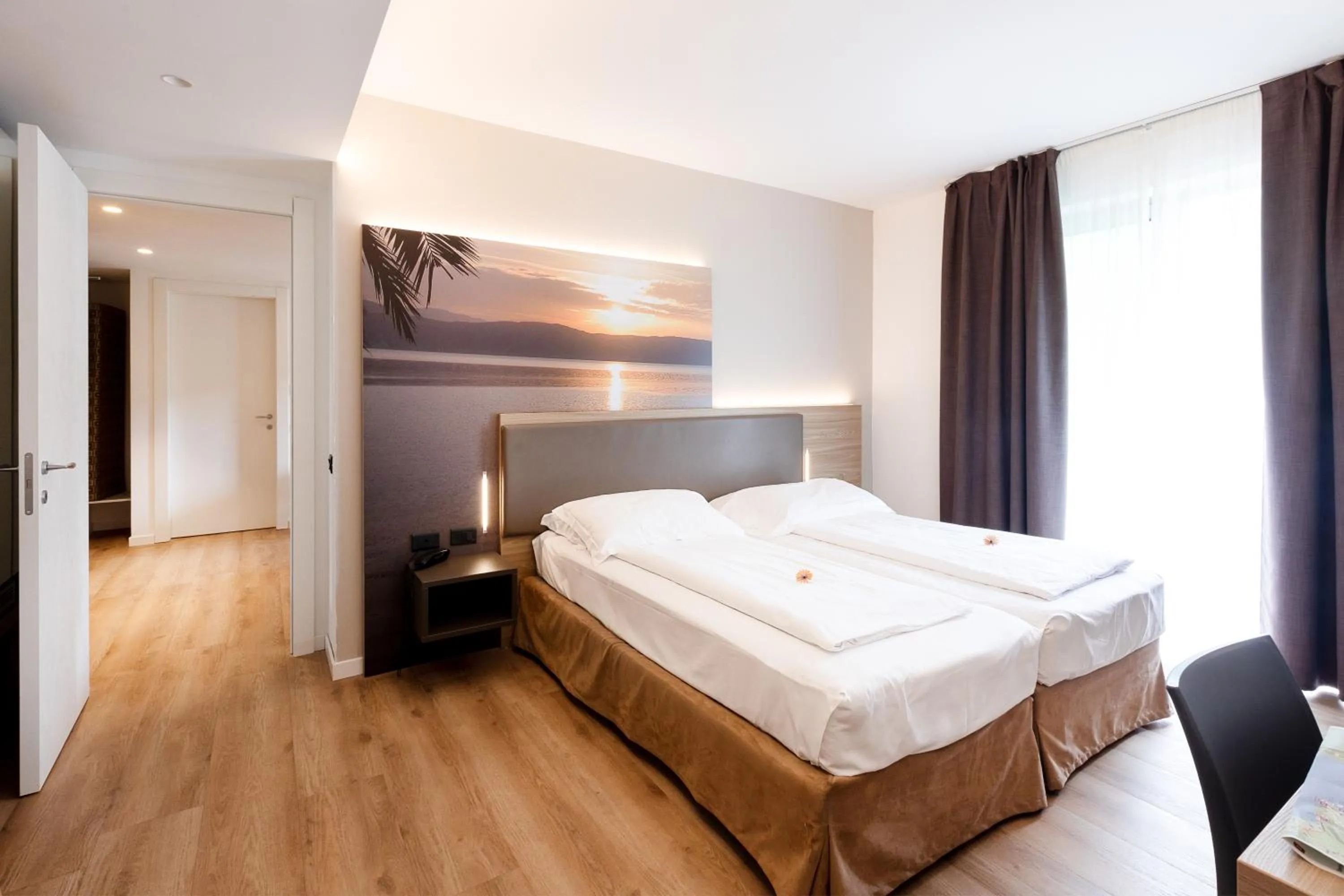 Bed in Ambassador Suite Hotel