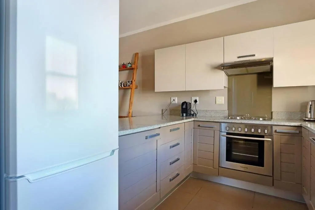 Kitchen or kitchenette in Penguin Haven . Luxury 2 bedroom, Boulders Beach.