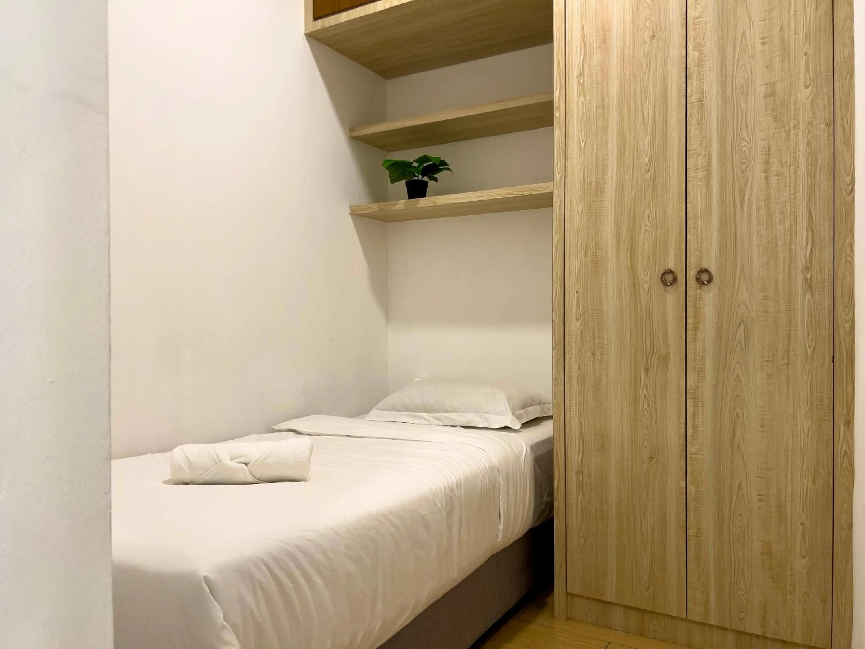 Bed in Hush Inn at ITCC Manhattan Suites