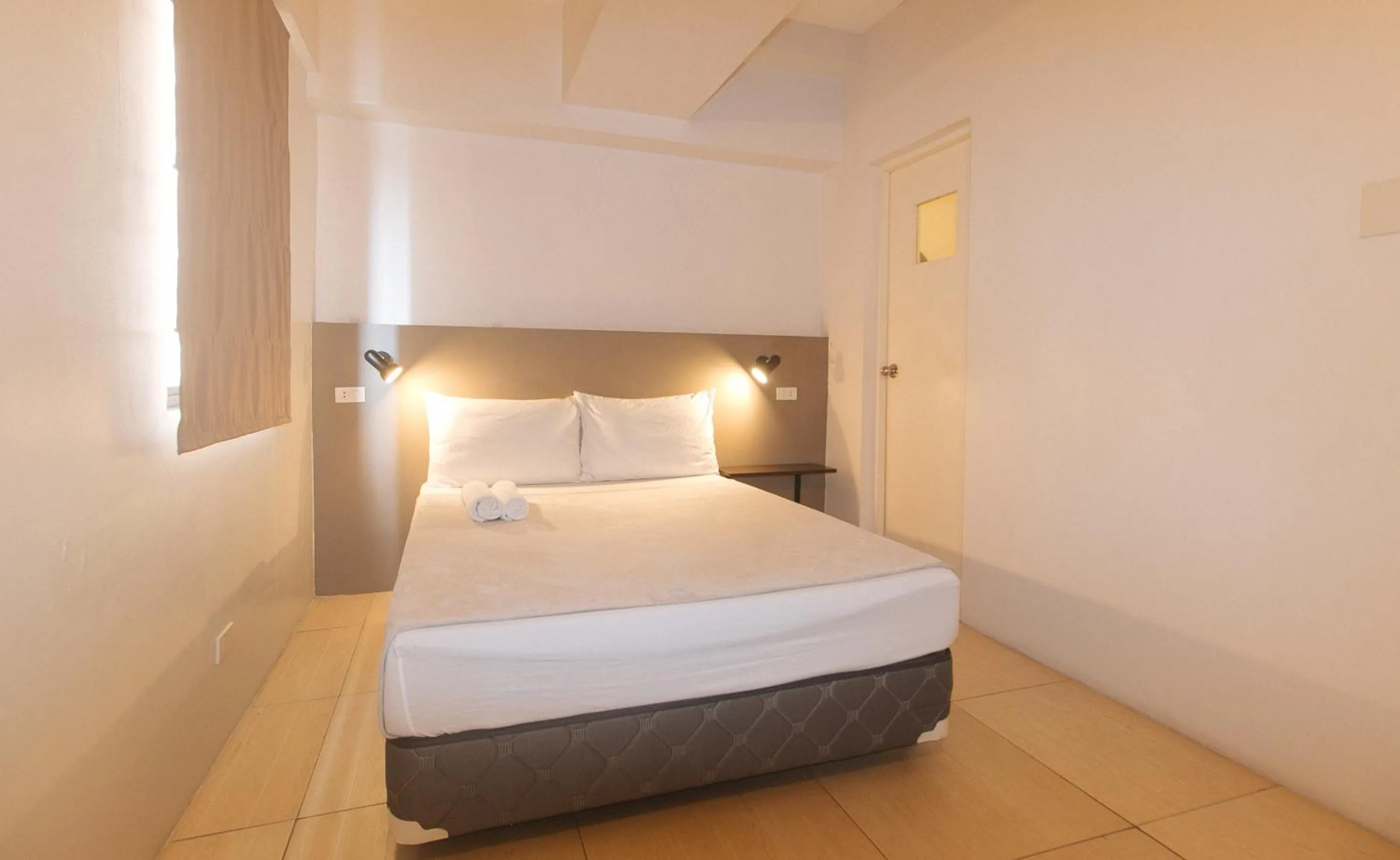 Bed in 59 Xavierville by RedDoorz