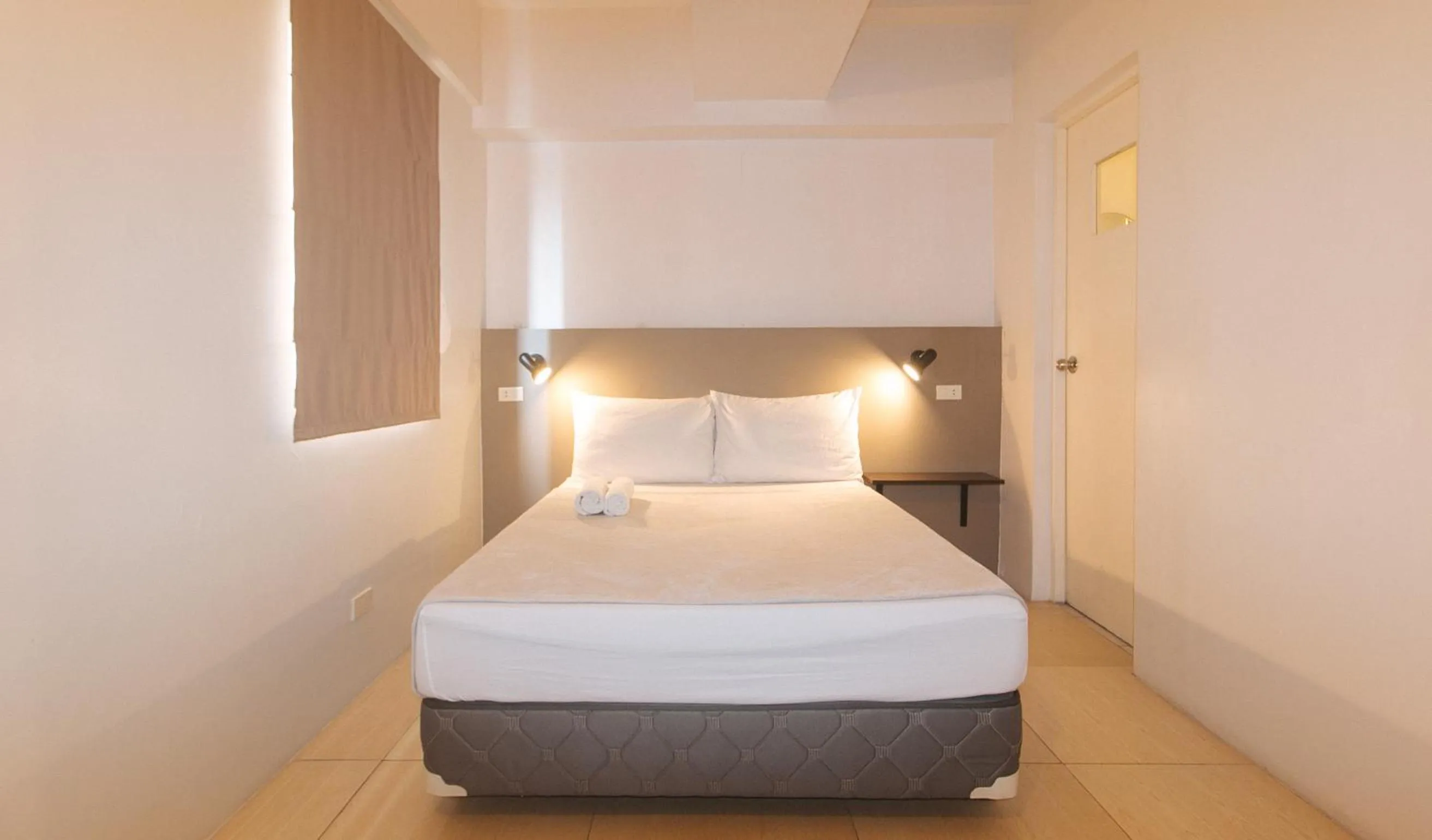 Bed in 59 Xavierville by RedDoorz