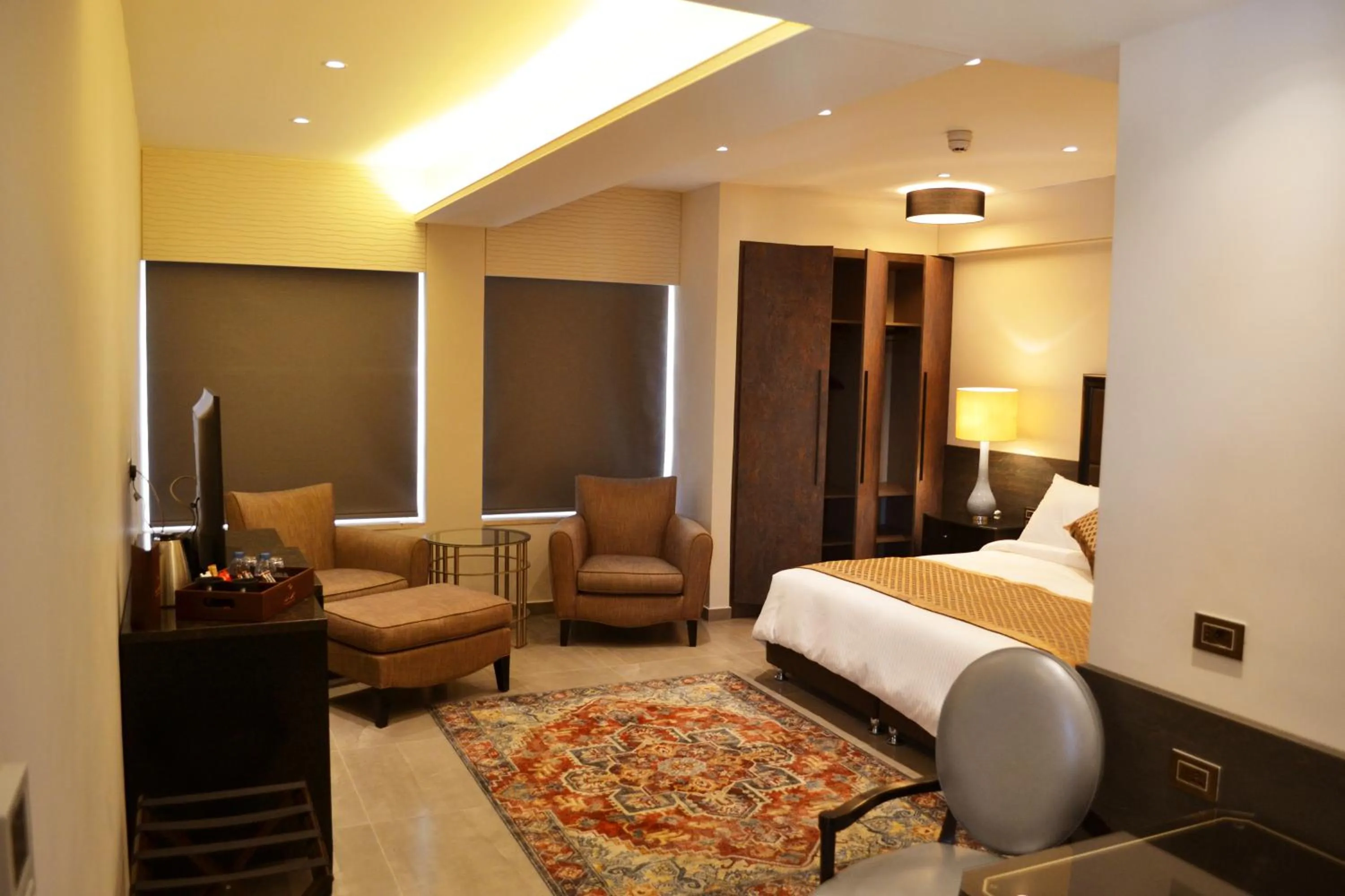 Living room, Bed in Ambassador, a Boutique Hotel