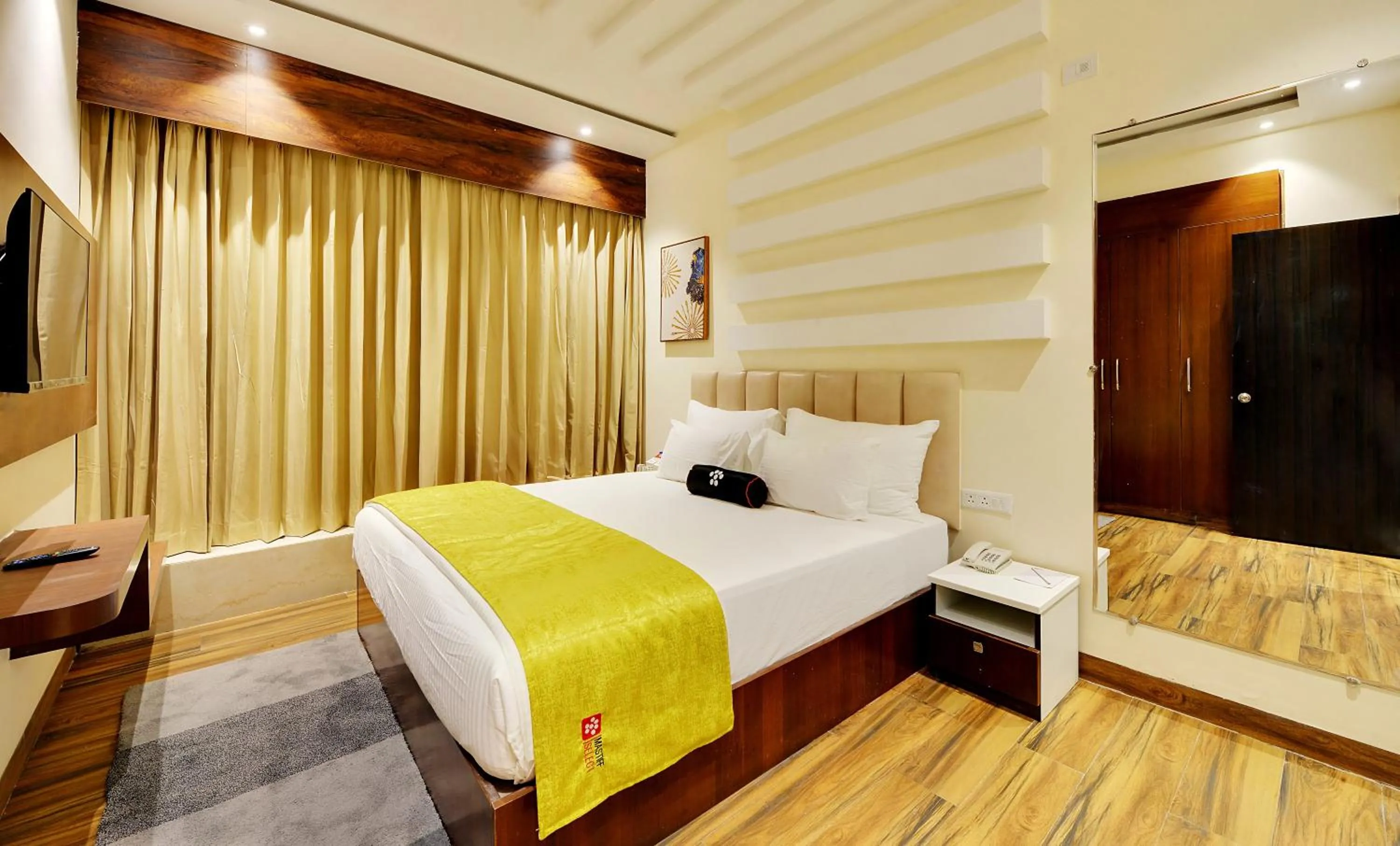 Bed in Mastiff Select Gulbarga Hotel