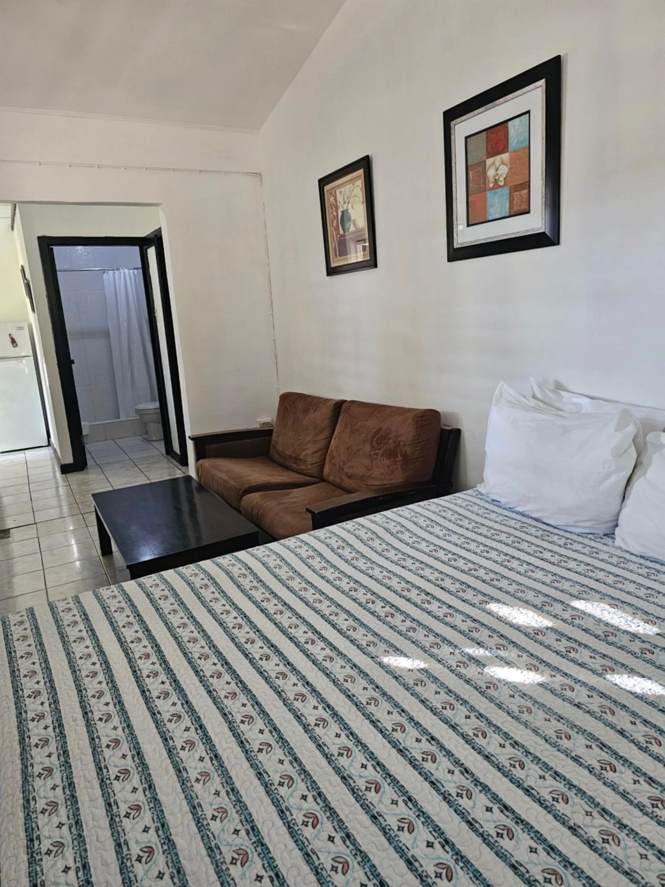 Bed in Roots Cafe Rooms