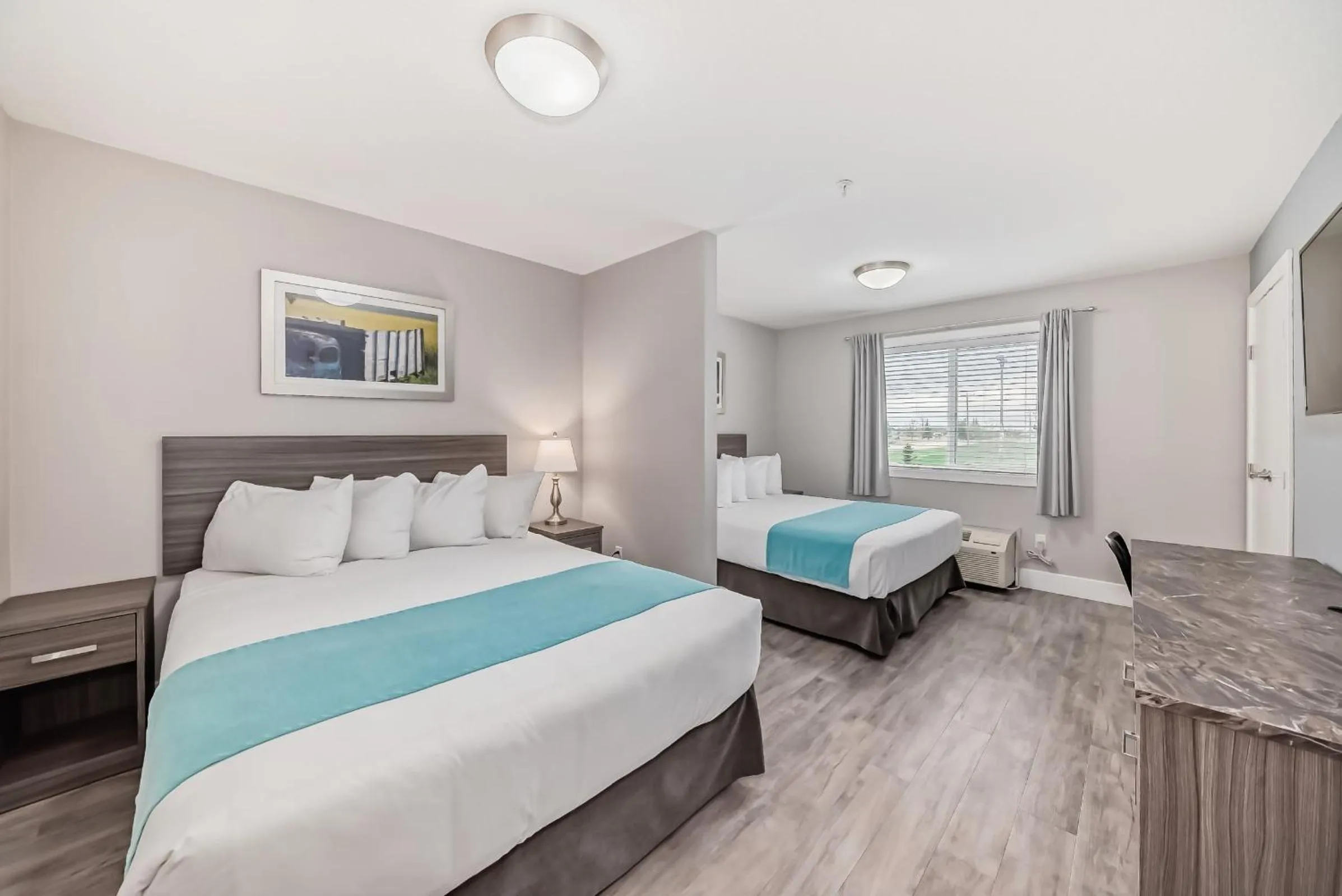 Bed in The Suites, INN Hotels