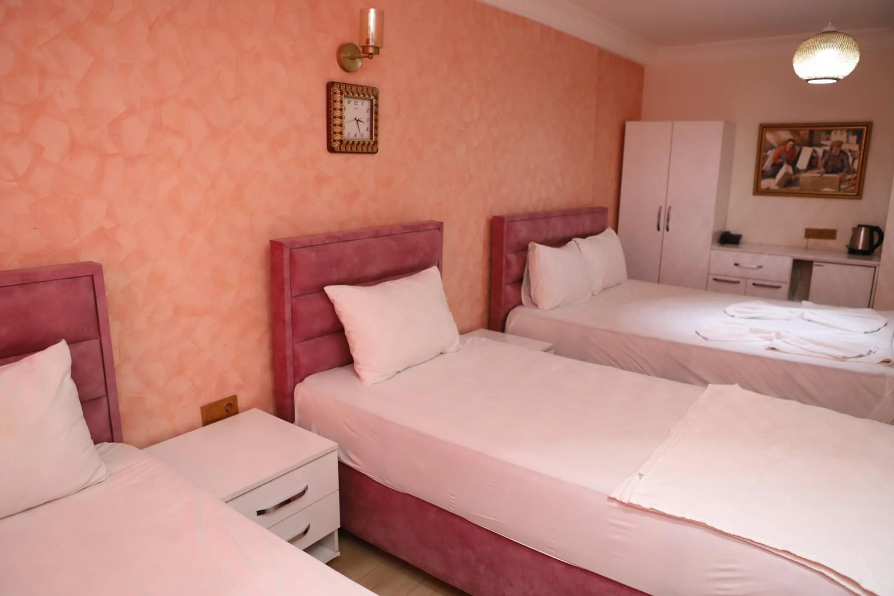 Bed in AVRASYAQUEEN HOTEL