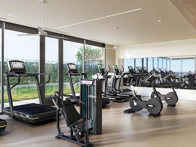 Fitness centre/facilities in Upscale Rainey St Condo Homes - Peloton, gym, rooftop pool, wifi included