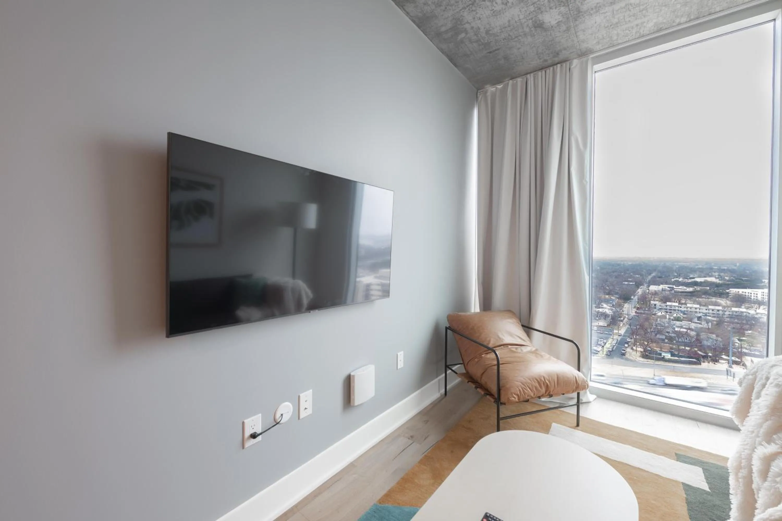 TV and multimedia in Upscale Rainey St Condo Homes - Peloton, gym, rooftop pool, wifi included
