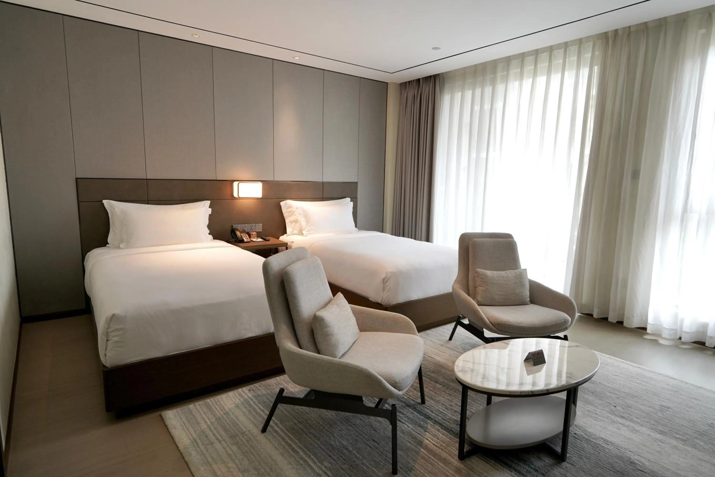 Seating area, Bed in Oakwood Premier Phnom Penh