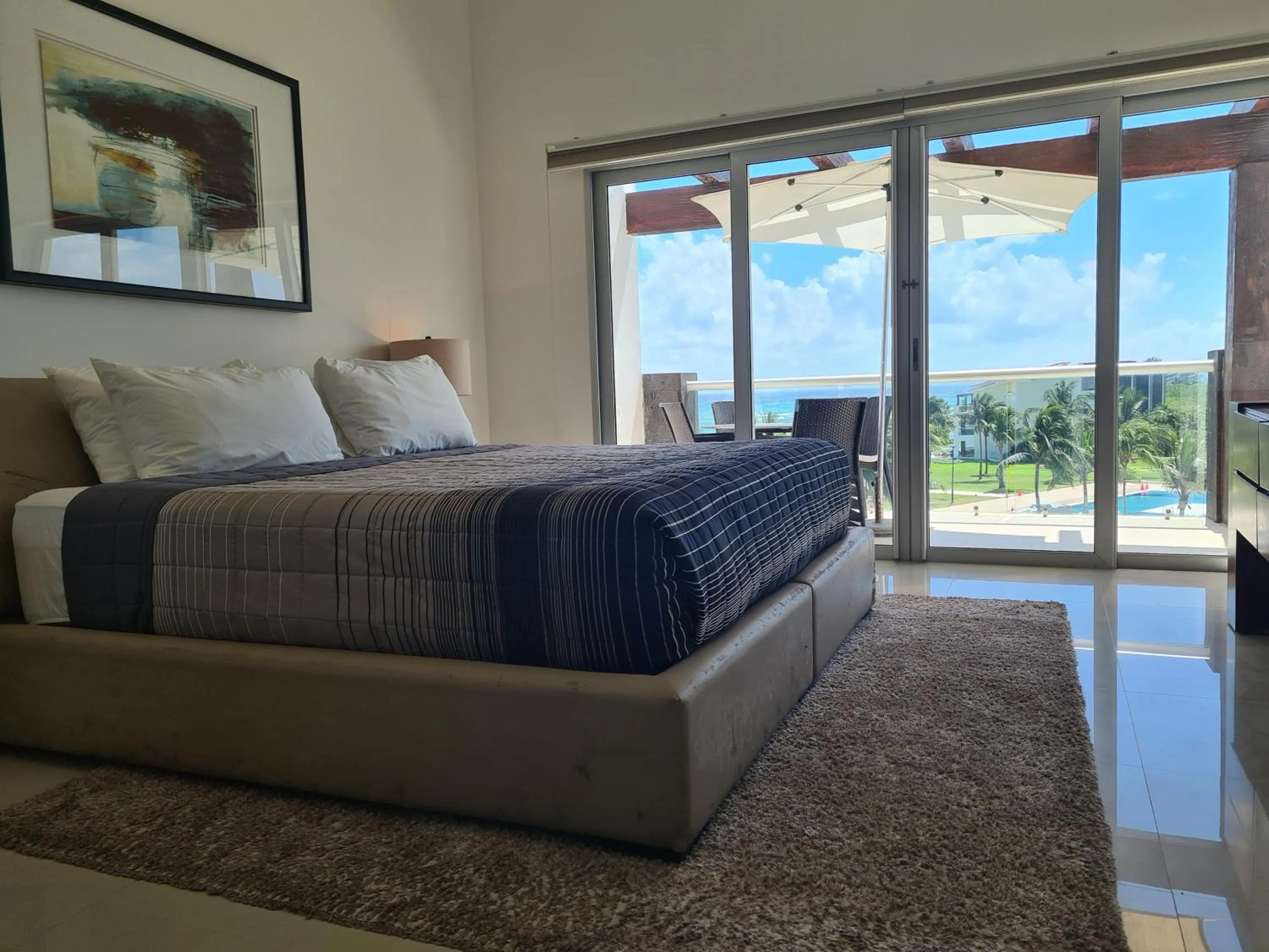Bed in Luxury ocean view penthouse and private beach club