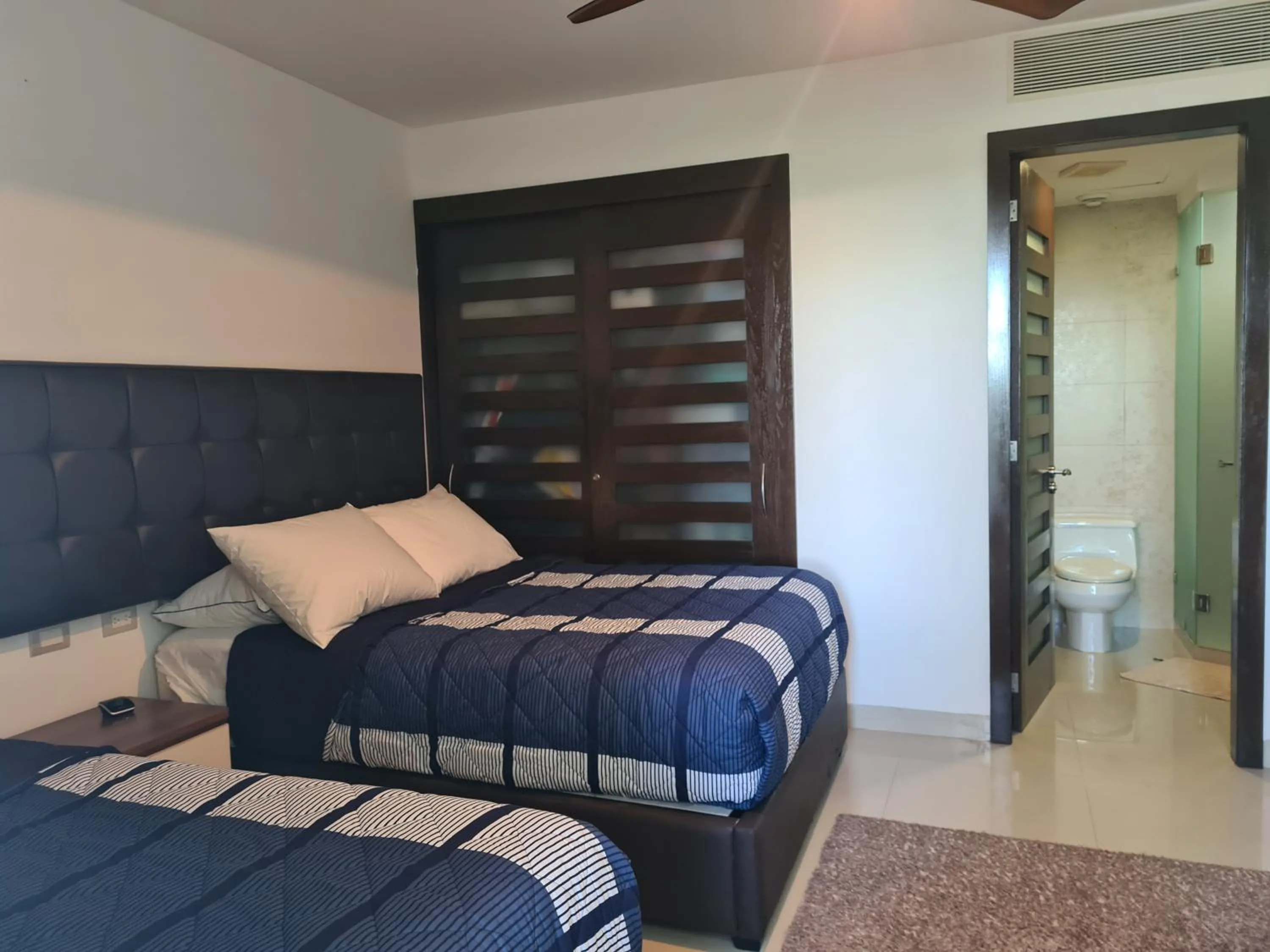 Bed in Luxury ocean view penthouse and private beach club