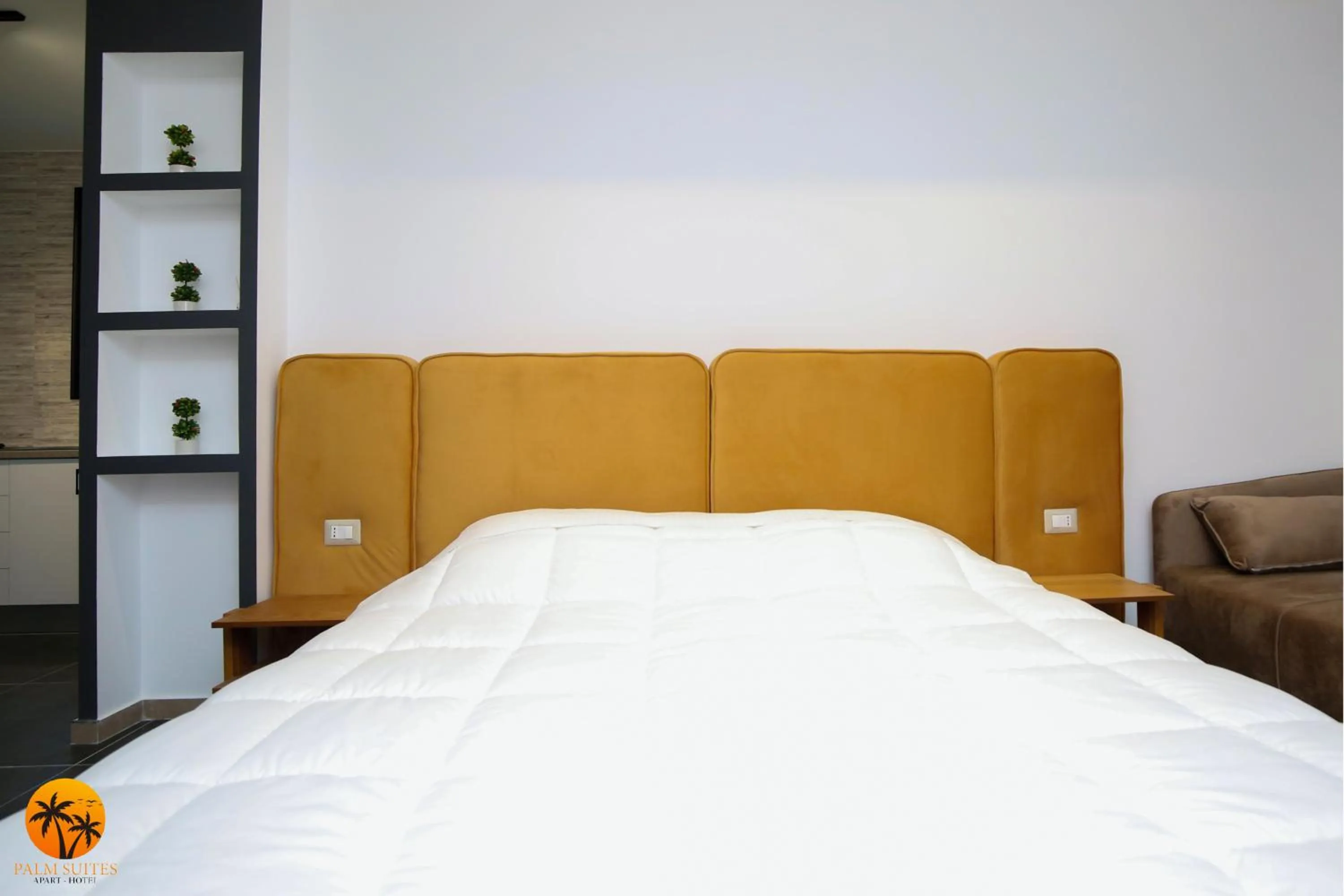 Bed in Palm Suites Apartment-Suite