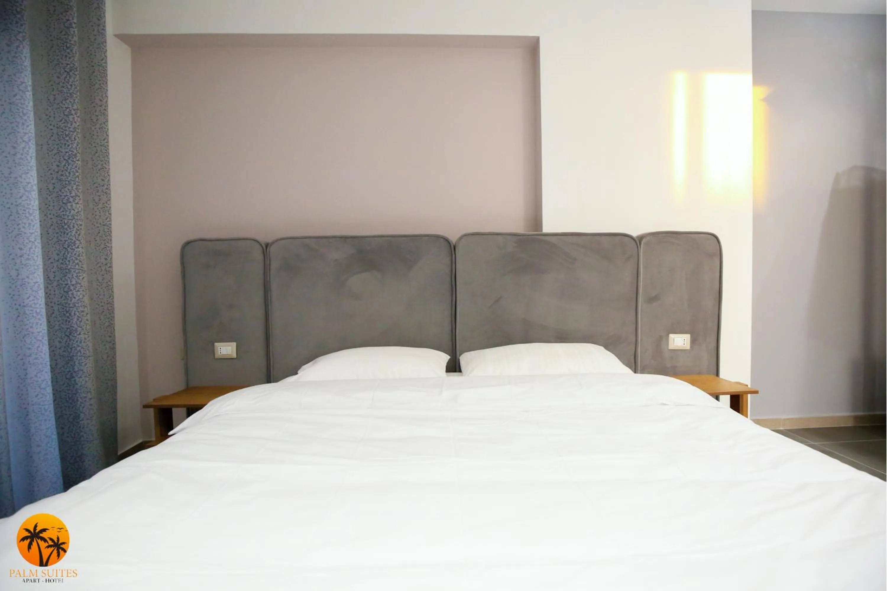 Bed in Palm Suites Apartment-Suite