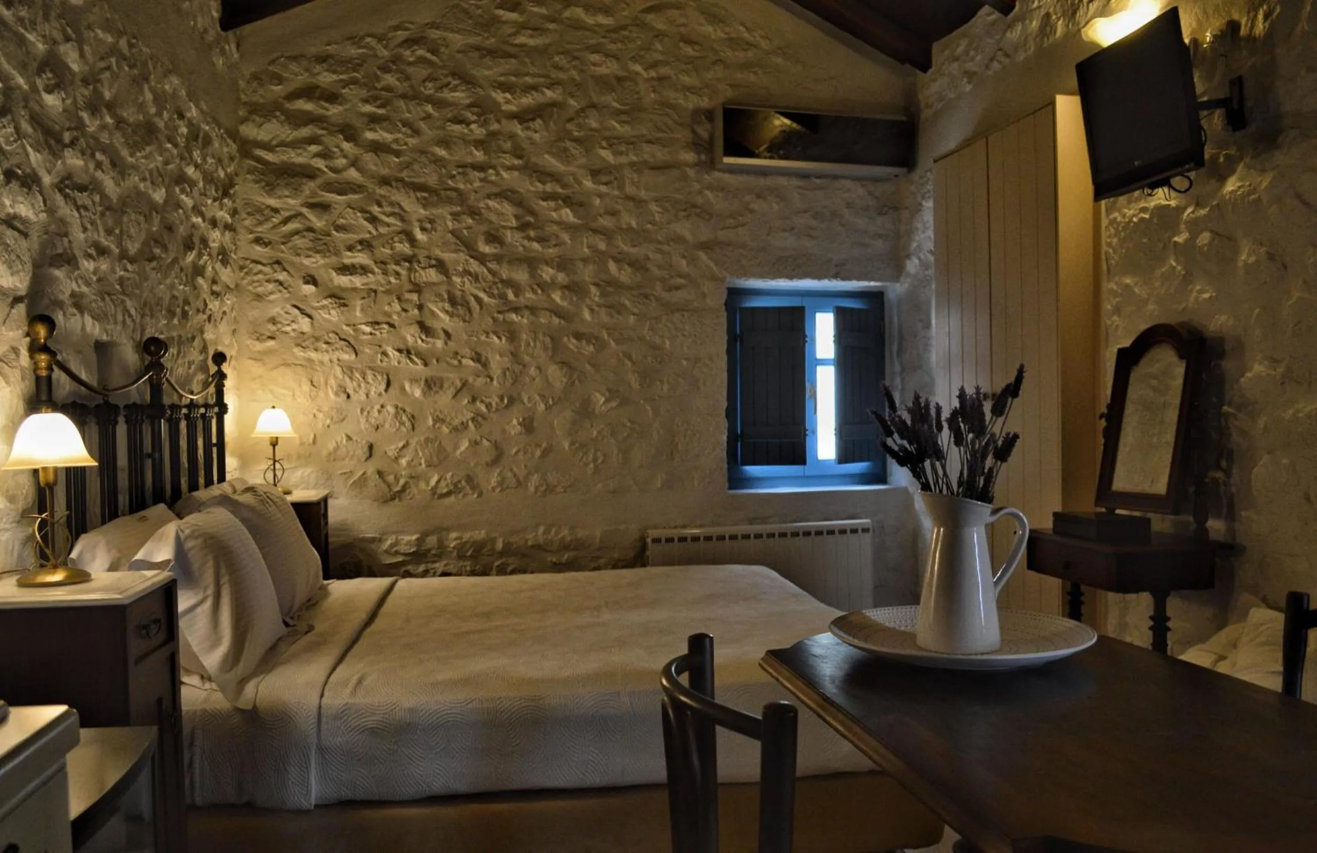 Photo of the whole room, Bed in Lithos Stone Suites