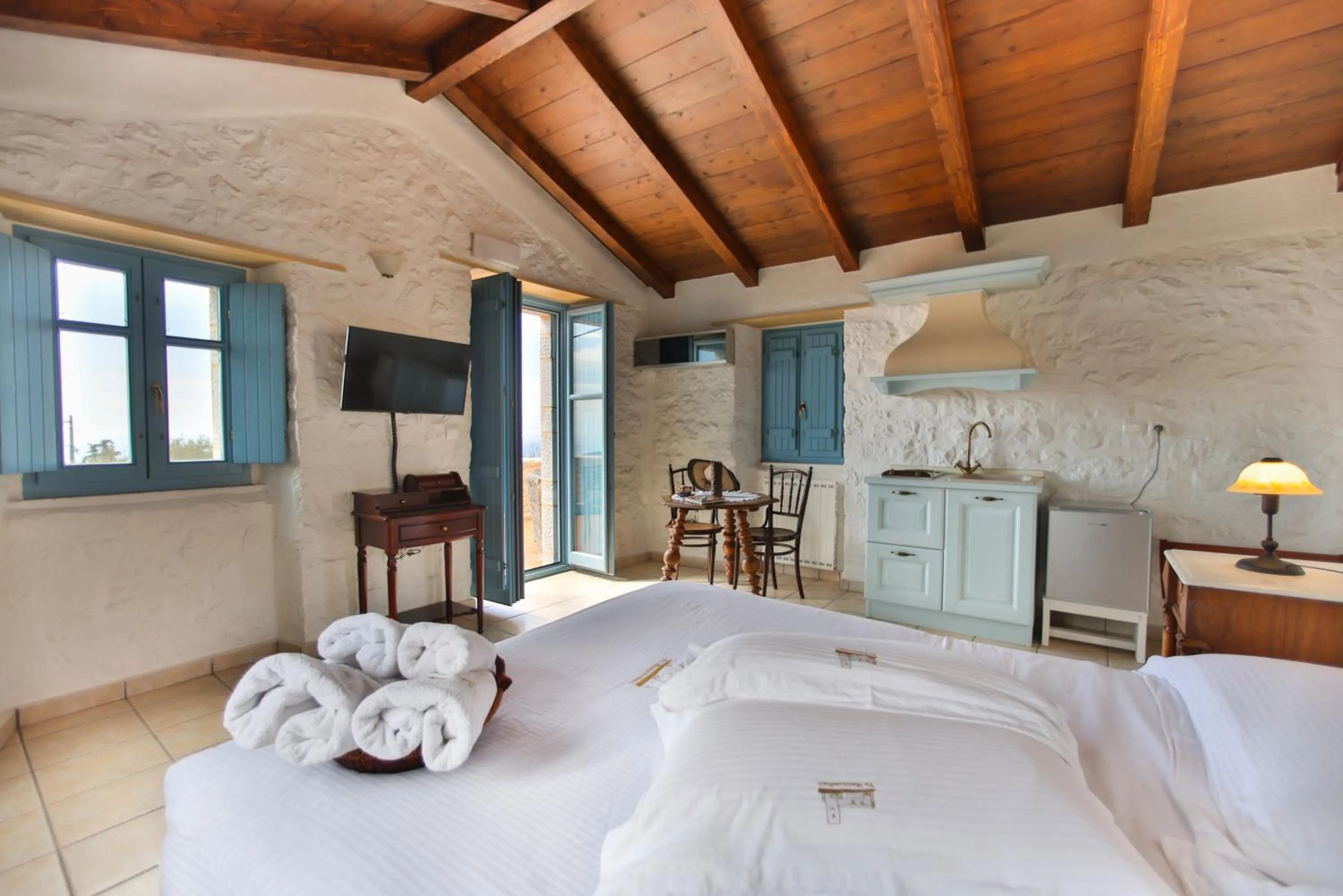 Photo of the whole room, Bed in Lithos Stone Suites