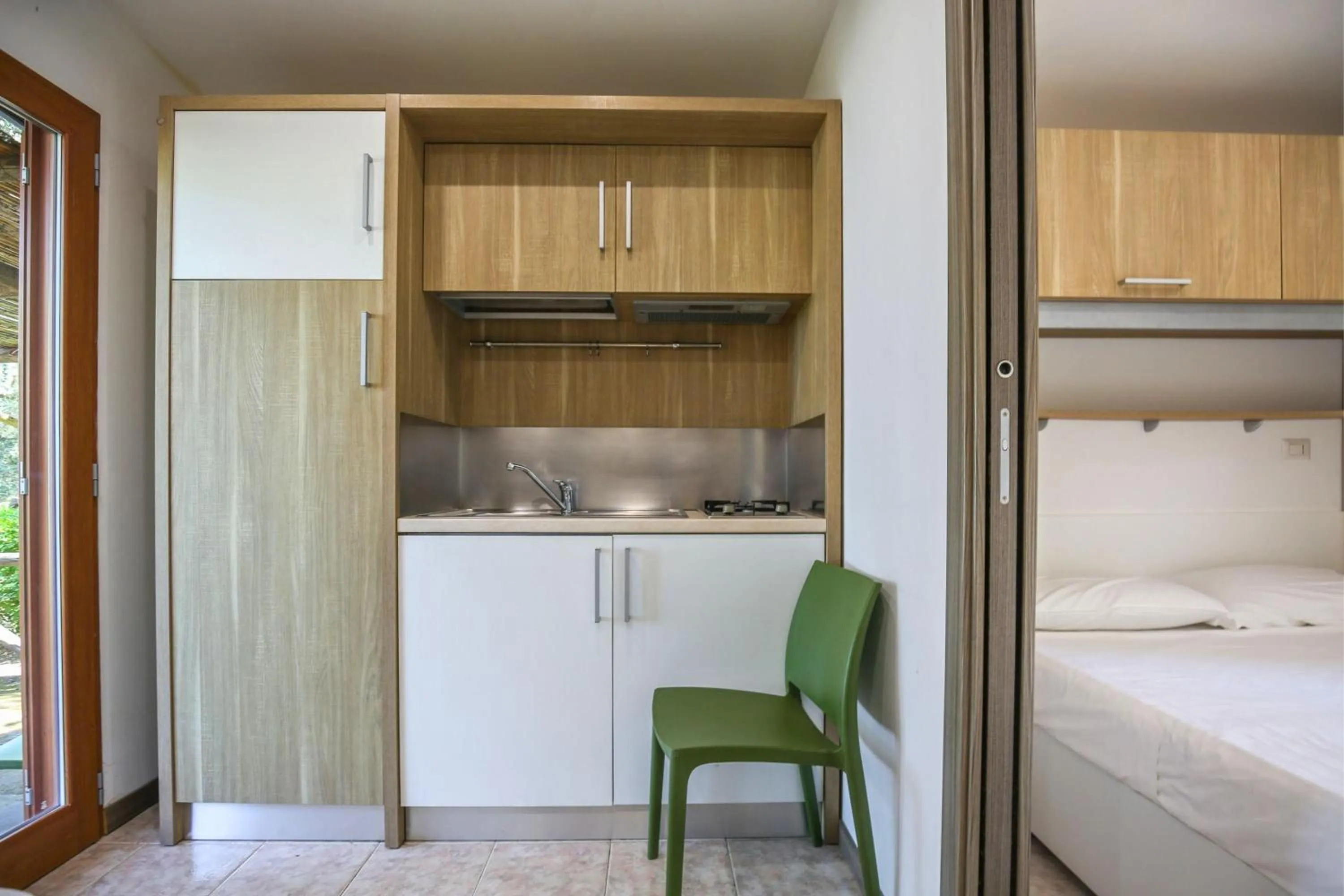 Kitchen or kitchenette, Bed in Village Camping Santa Fortunata - Campogaio
