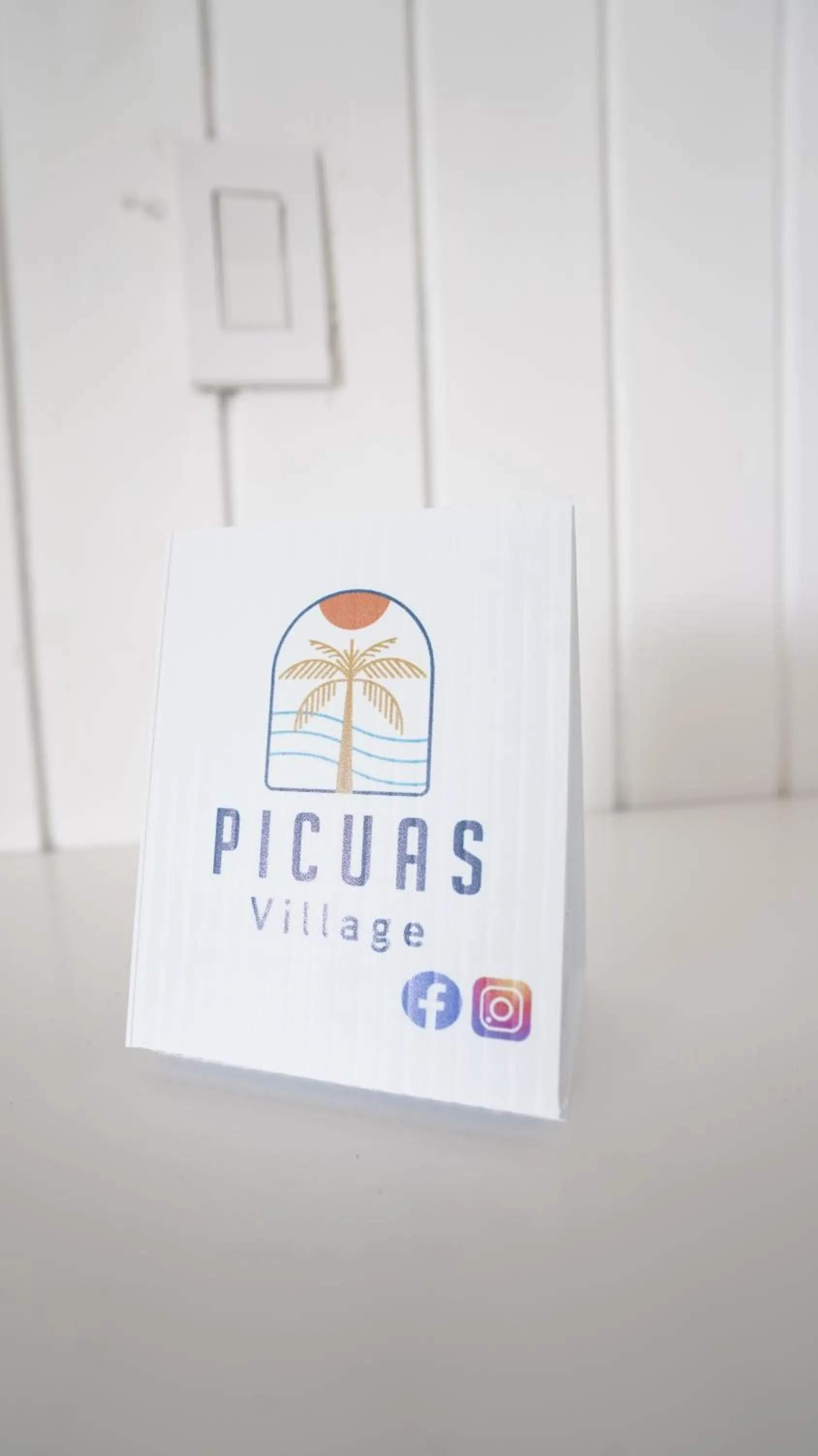 Property logo or sign in Picuas Village