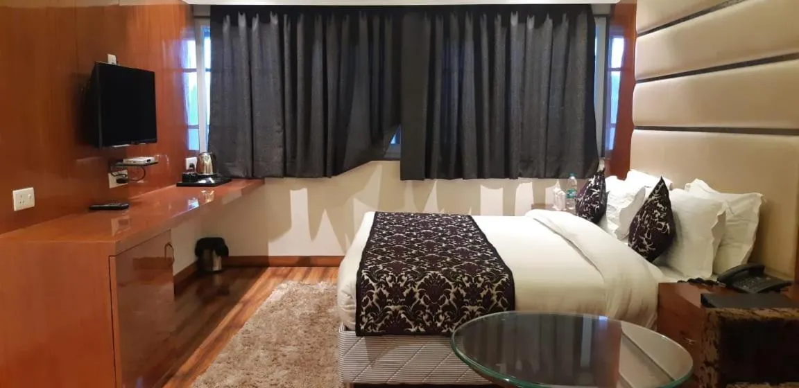 Communal lounge/ TV room, Bed in Grand Geet Hotels