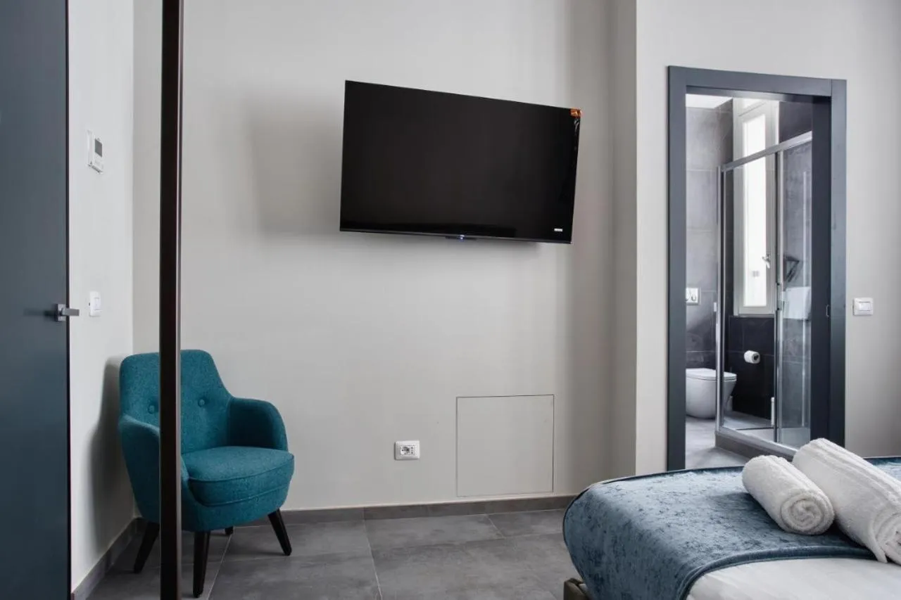 Communal lounge/ TV room, Bed in Hotel Vitruvio