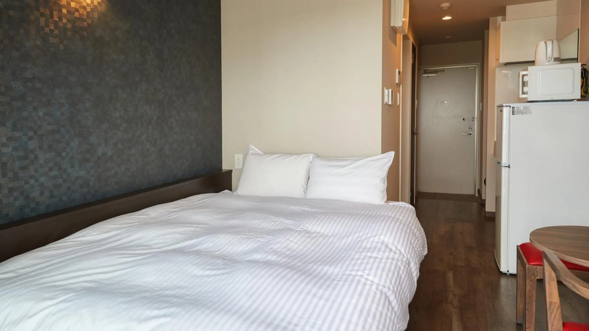 Bed in New Normal Condo in NAHA AIRPORT ニューノーマルコンドイン那覇エアポート
