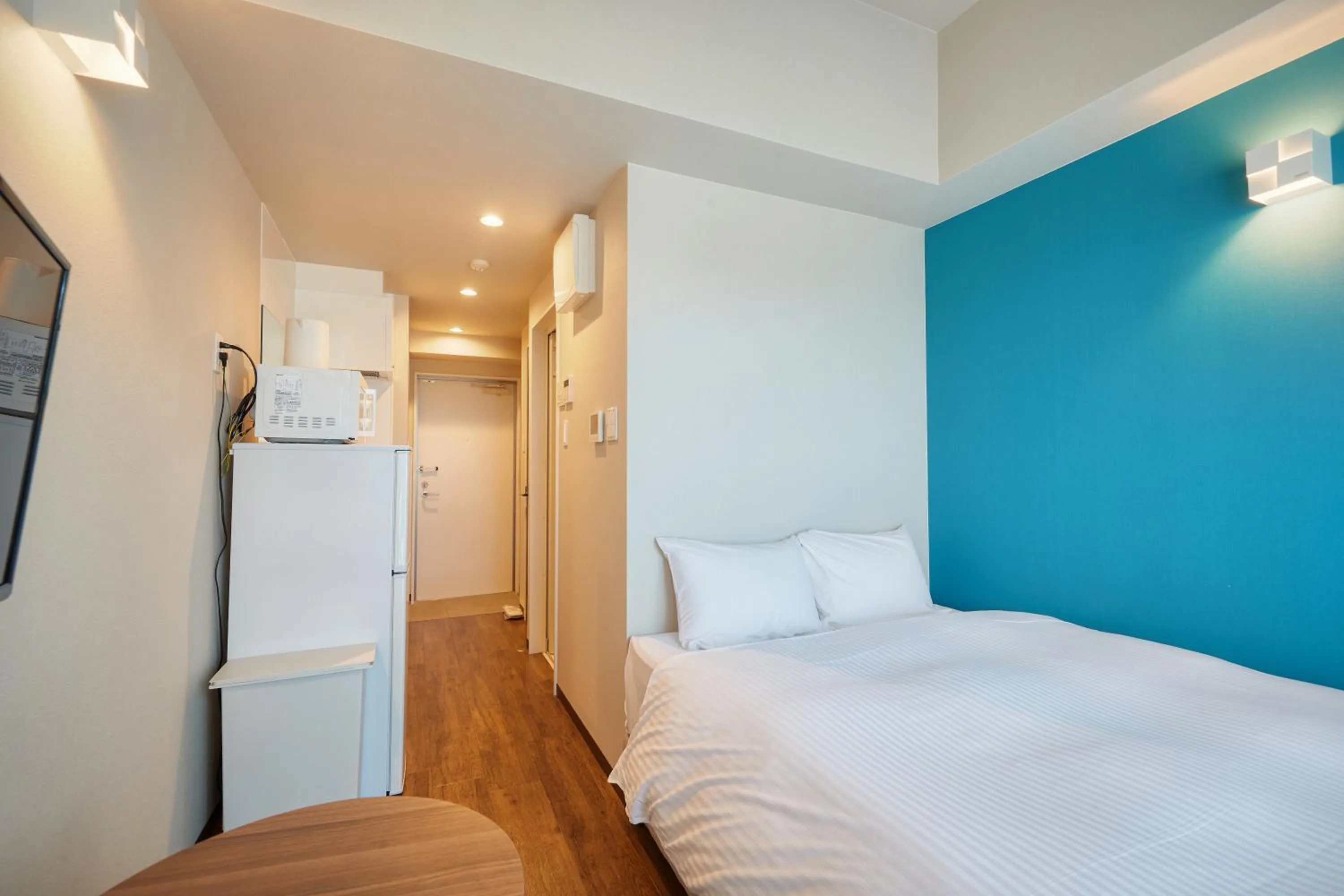 Bed in New Normal Condo in NAHA AIRPORT ニューノーマルコンドイン那覇エアポート